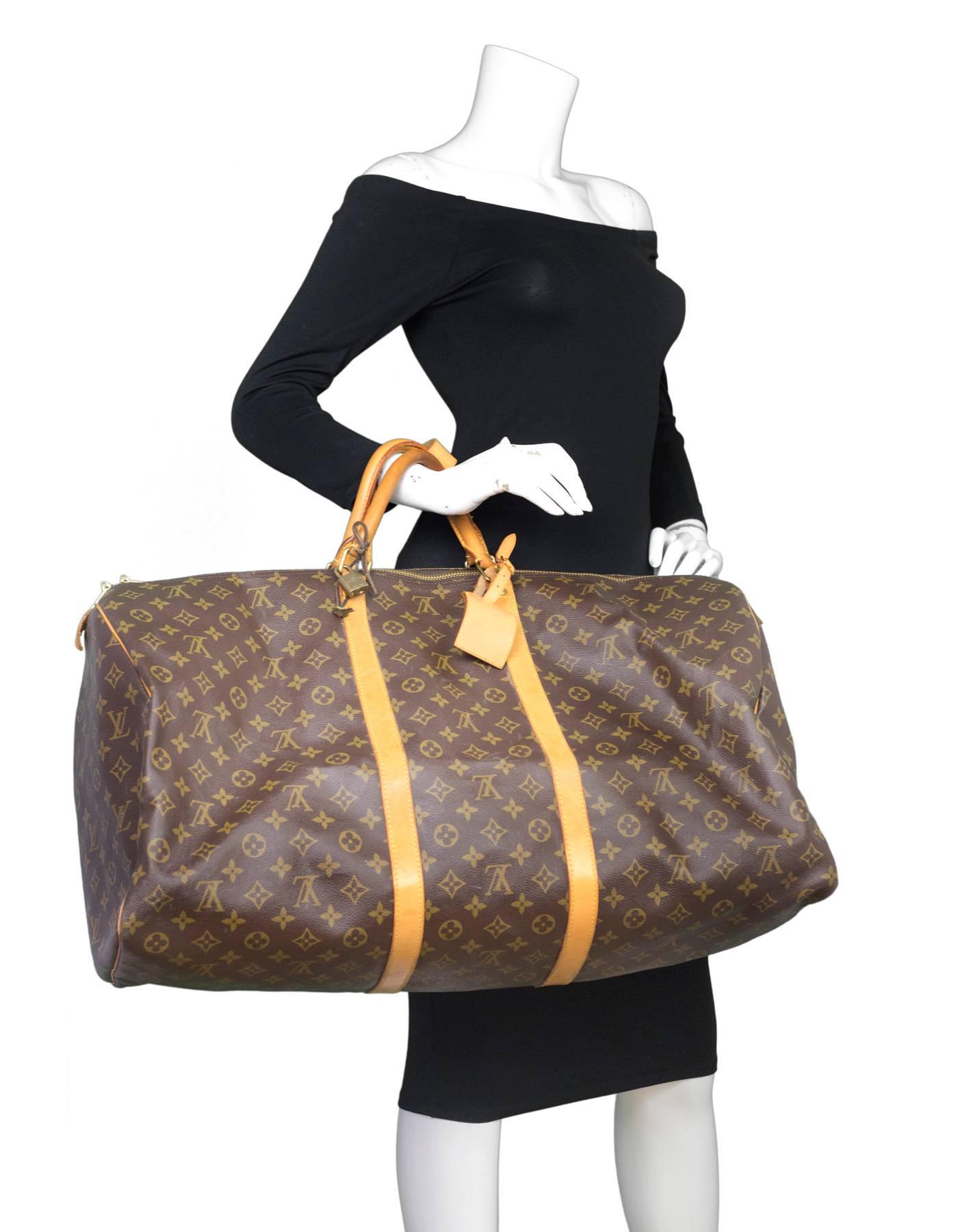 100% Authentic Louis Vuitton Monogram Keepall 60. Features all-over monogram print with aged tan leather handles and brass hardware. Brown textile interior. Comes with lock and luggage tag. Excellent pre-owned condition with the exception of fading