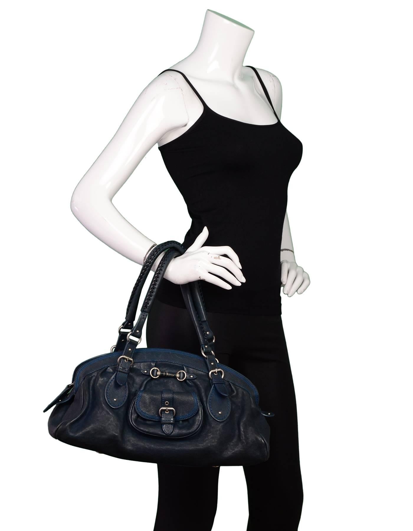 100% Authentic Christian Dior Blue Bowler Bag. Features snap closure pocket with buckle detail and horsebit with Dior logo on front. Pleating on front and back. Shoulder straps with cross stitch detail, silver hardware, zip top. Black leather lining