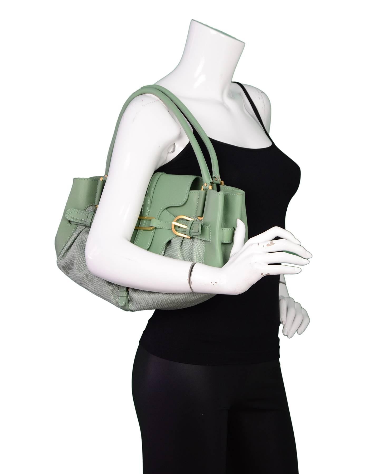100% Authentic Jimmy Choo Raffia Tulita Bag. Features green raffia with leather handles and trim. Flap top opening with two shoulder straps. Buckle details on front with gold hardware. Tan suede lining with one interior zip pocket and one wall