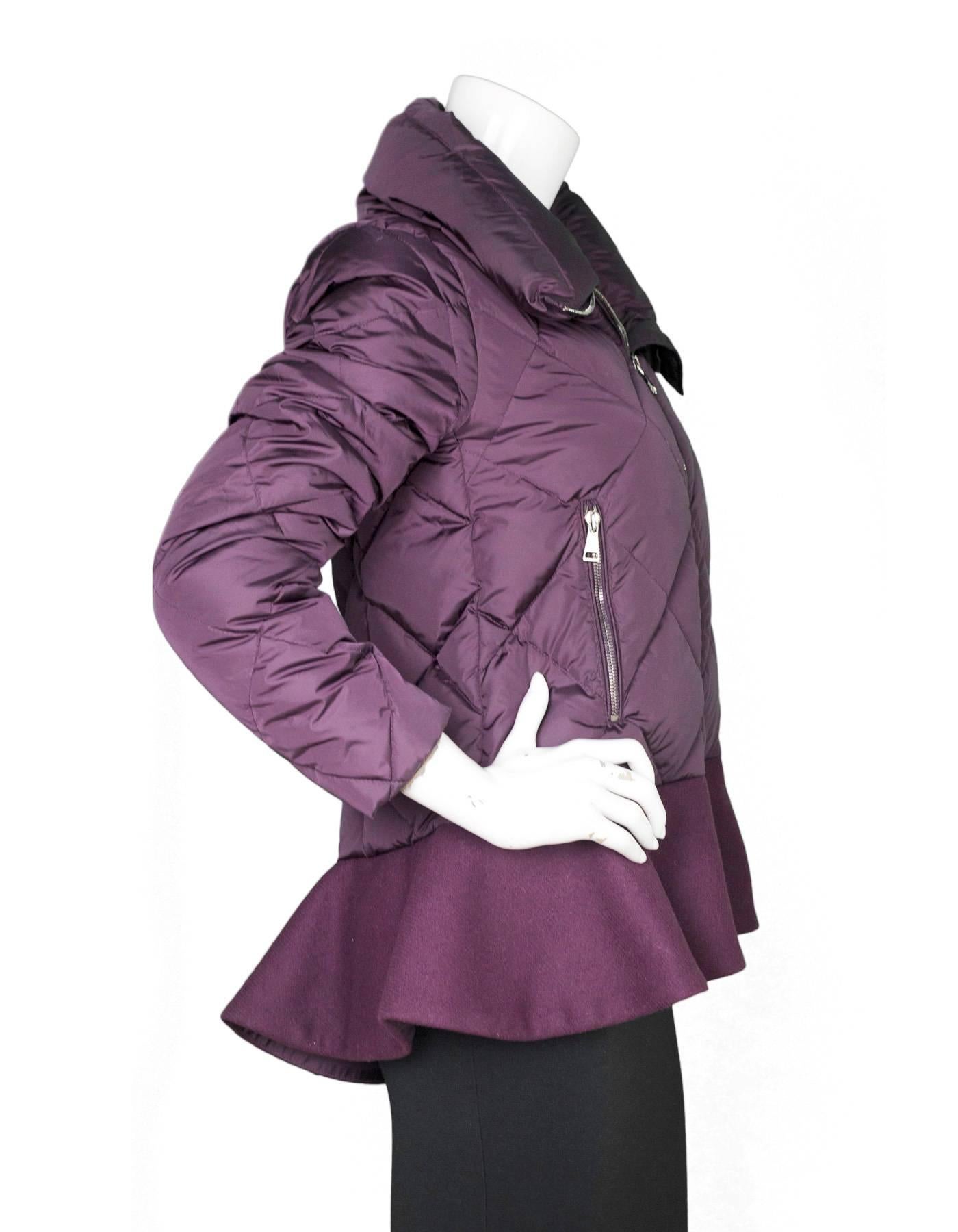 Moncler Eggplant Puffer Coat 
Features ruffle/peplum at bottom of coat.  Please note this style was not made with the Moncler patch on the sleeve or the cartoon to the interior.

Made In: Hungary
Color: Eggplant
Composition: 100% Polyamide
Lining:
