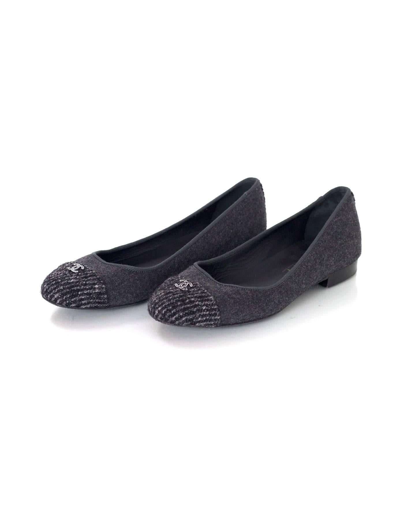 Chanel Grey Felted Ballet Flats 
Features black and grey tweed at toe cap with CC charm on top

Made In: Italy
Color: Grey and black
Materials: Felted wool
Closure/Opening: Slide on
Sole Stamp: CC Made in Italy 37
Overall Condition: Excellent