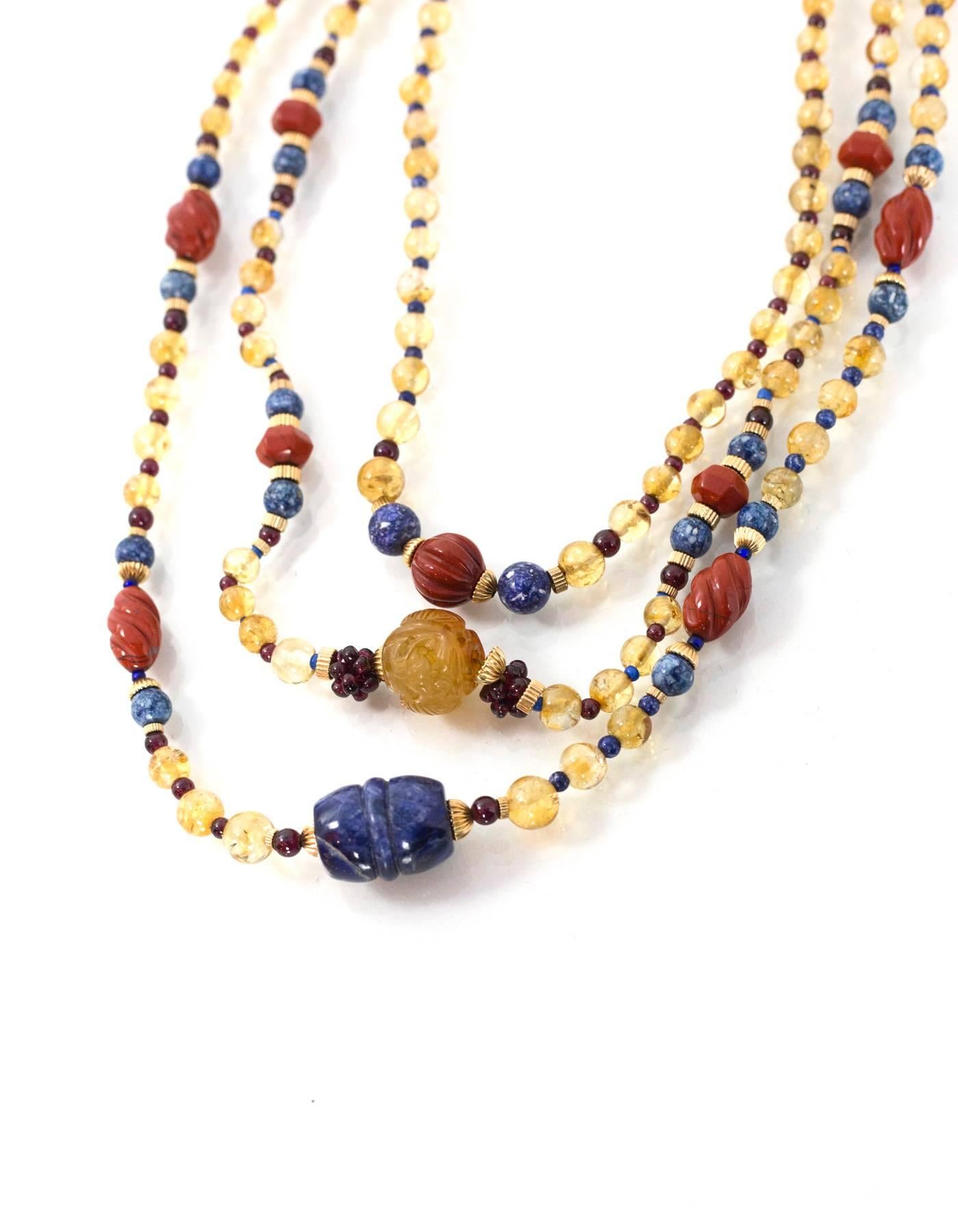 Multi-Colored 3 Strand Beaded Semi-Precious Stone Necklace 
Features vermeil hardware closure

Color: Blue, navy, burgundy, amber and citron
Materials: Semi-precious stones
Closure: Hook and eye closure
Stamp: Sterling
Overall Condition: Excellent