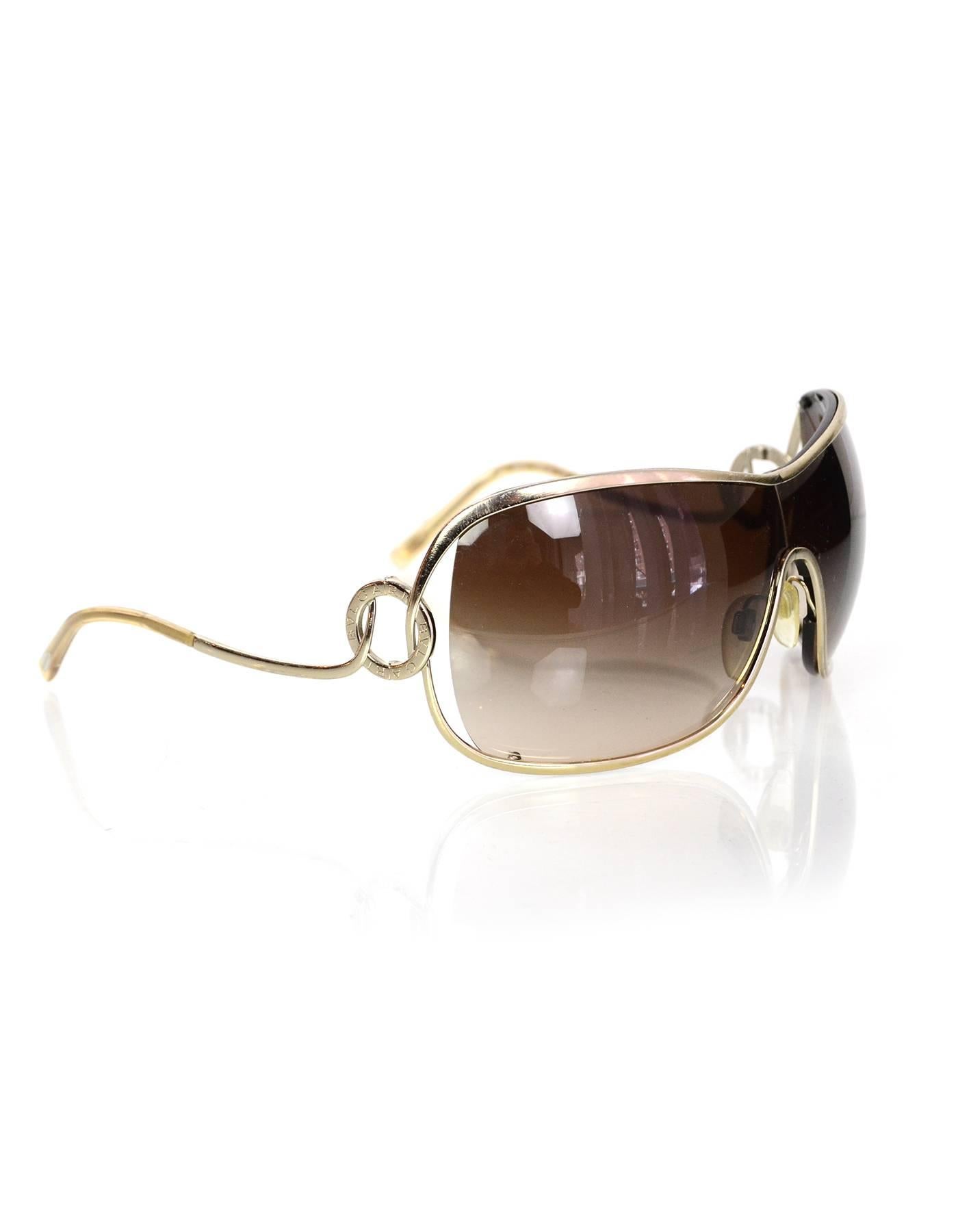 100% Authentic Bulgari Gold Frame Sunglasses. Features gradiant lenses in an oversized wrap-around shape. Gold metal frame with circular detail and logo at temple. Comes with original box and case. Excellent pre-owned condition.

Made In: