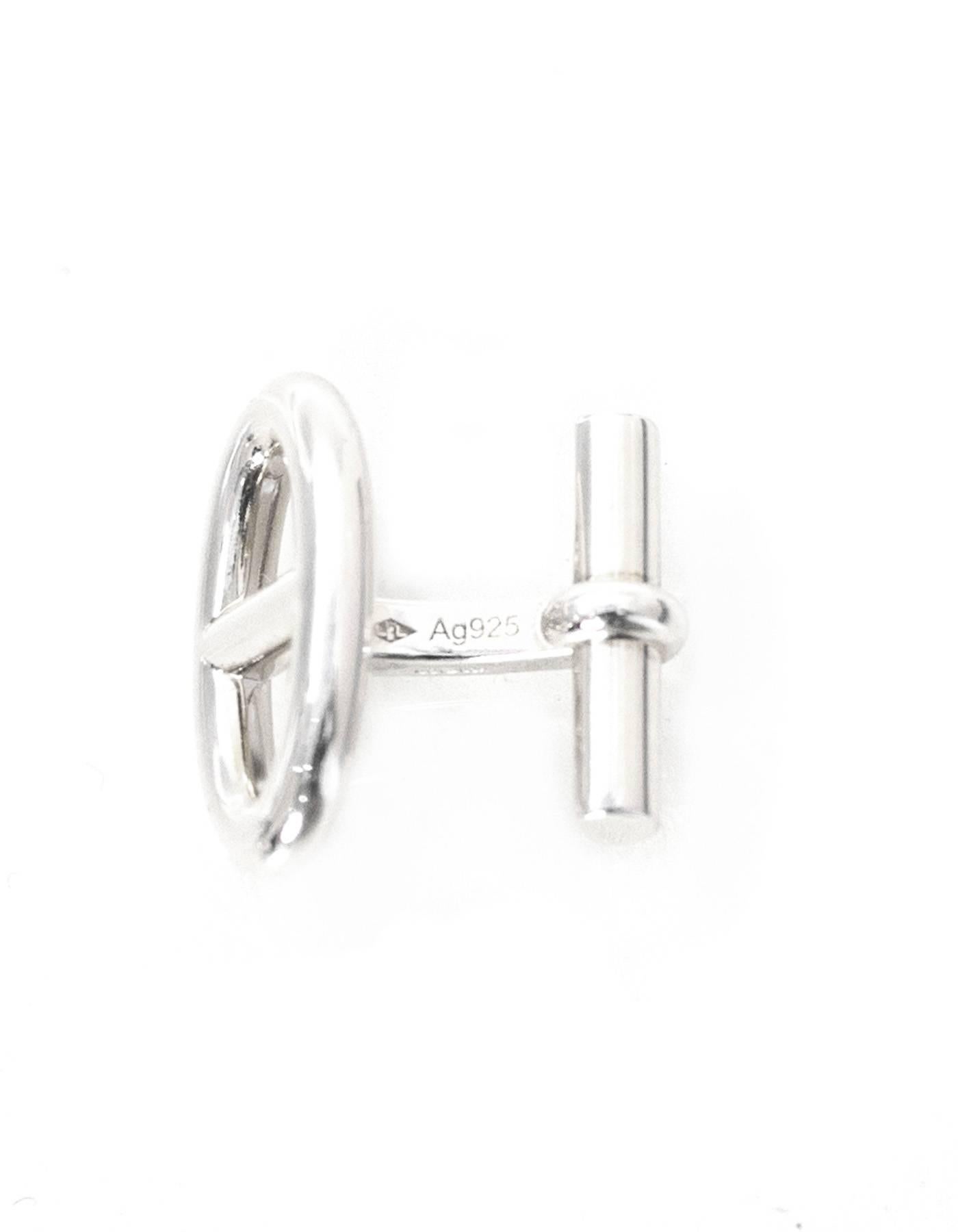 100% Authentic Hermes Marine Silver Cufflinks. Features sterling silver in an oval nautical shape. Comes with original box and bag. Excellent pre-owned condition.

Color: Silver
Materials: Sterling silver
Closure: None
Stamp: Hermes AG925