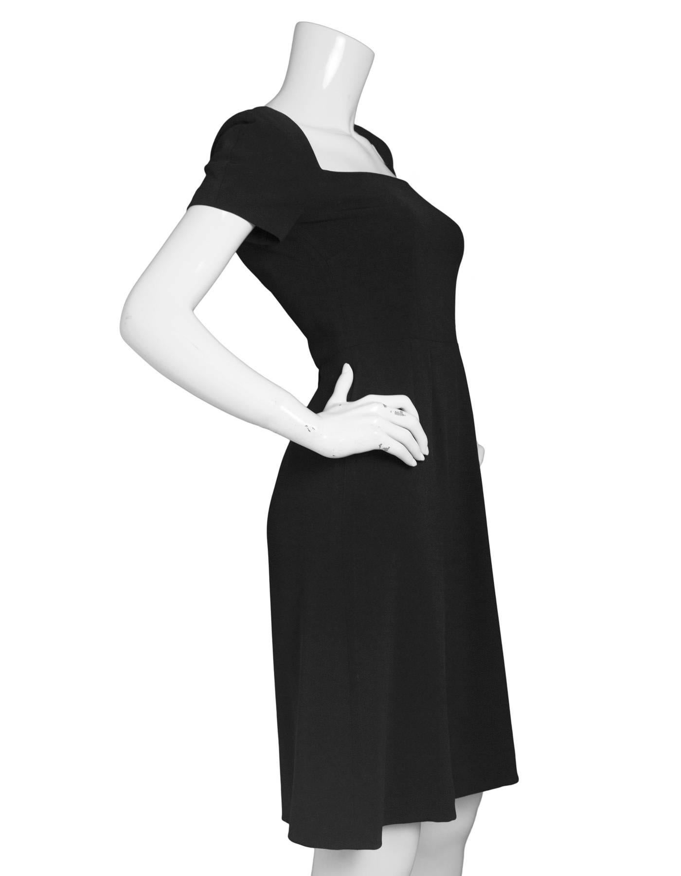 Dolce & Gabbana Black Short Sleeve Dress
Features square neckline with cap sleeves 

Made In: Italy
Color: Black
Composition: 70% viscose, 28% acetate, 4% elastane
Lining: Black, 94% silk, 6% elastane
Closure/Opening: Back zip up
Exterior