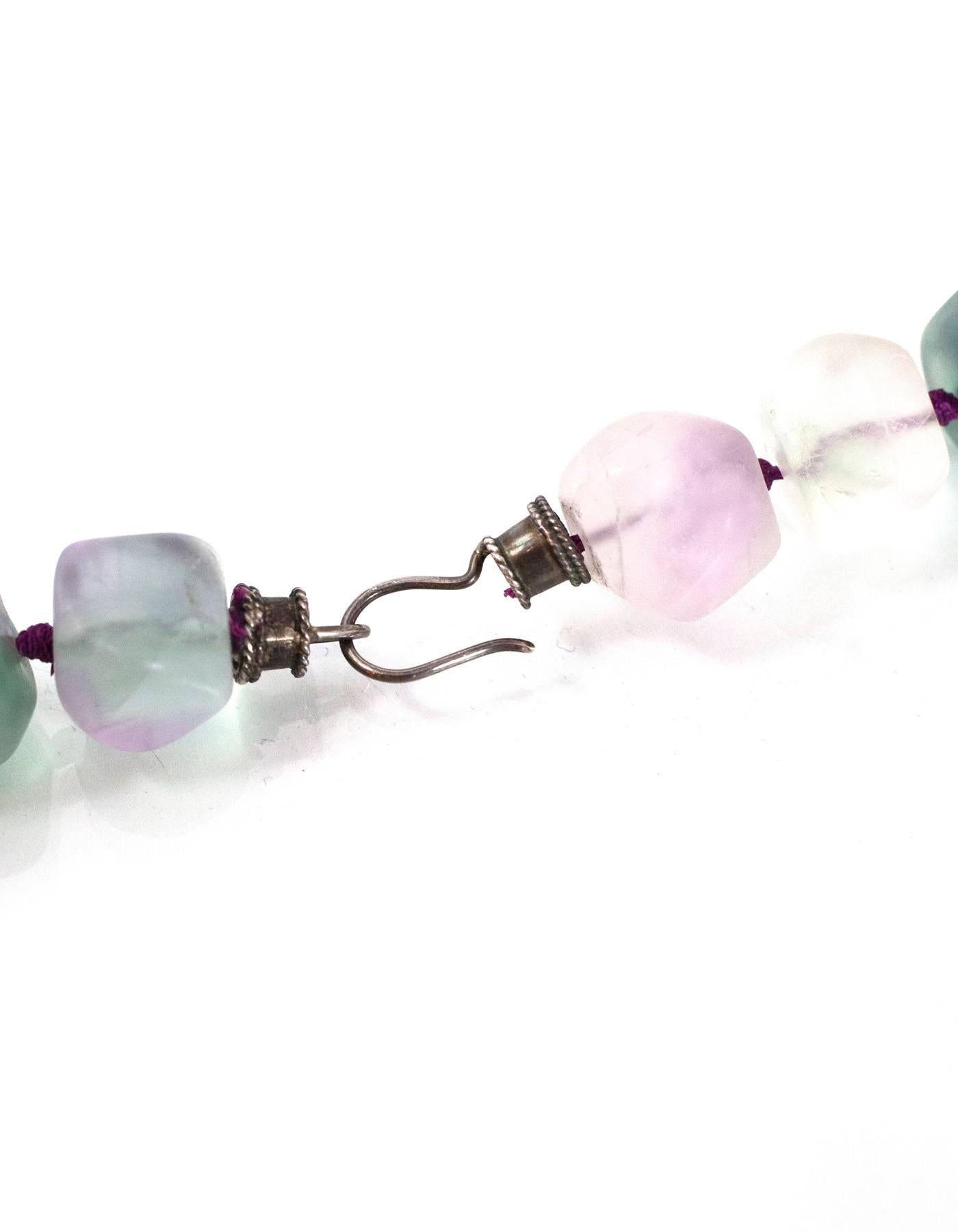 Green & Purple Semi-Precious Beaded Stone Collar Necklace 
Features purple knots between each stone
Color: Green, purple and clear
Materials: Semi-precious stones and metal
Closure: Hook and eye closure
Overall Condition: Excellent pre-owned
