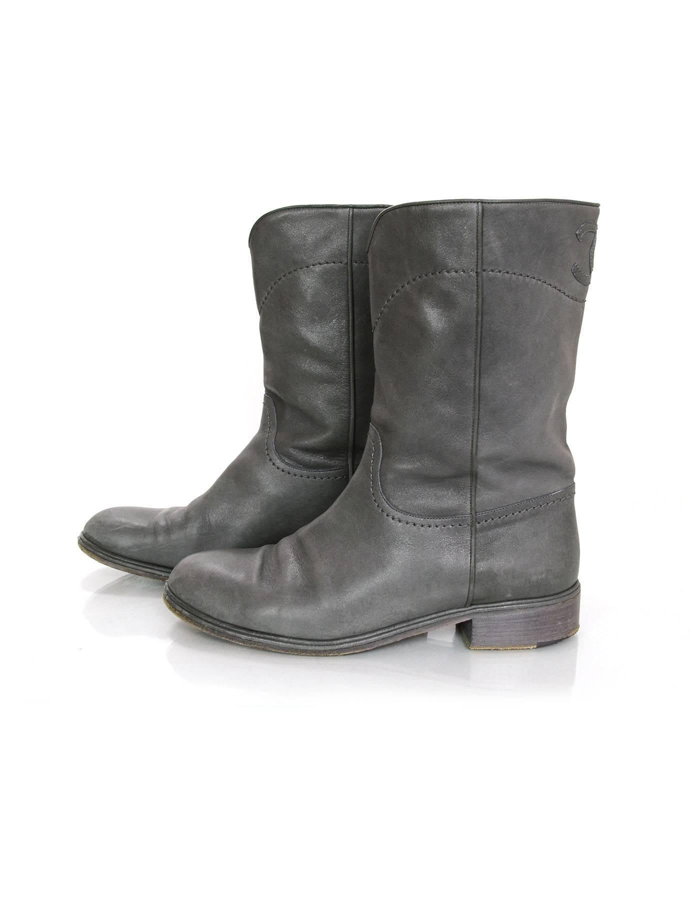 Chanel Grey Leather Calf-High Boots
Features stitched CC at back of boot shaft

Made In: Italy
Color: Grey
Materials: Leather
Closure/Opening: Pull on 
Sole Stamp: CC Made in Italy 41
Overall Condition: Very good pre-owned condition with the