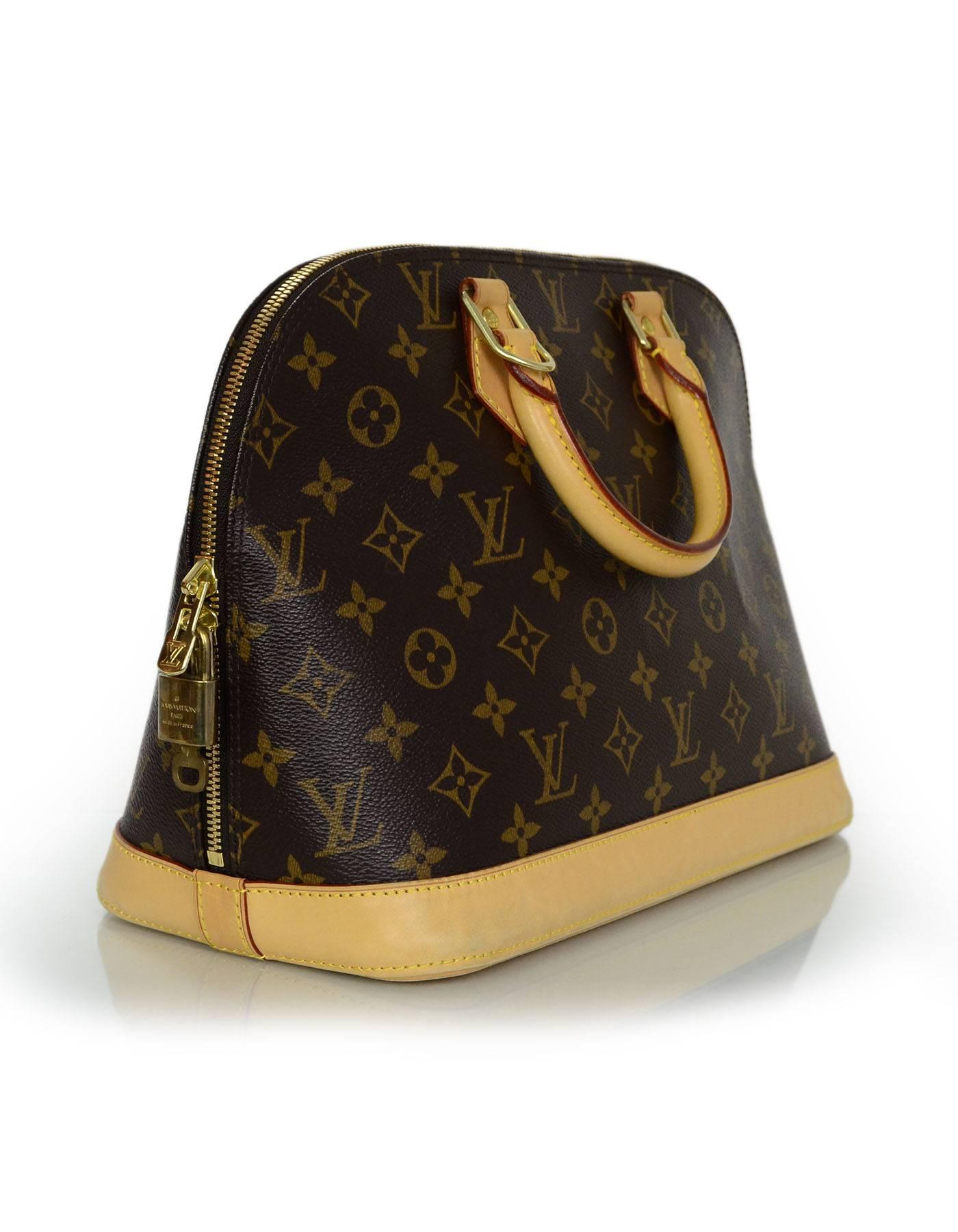 Louis Vuitton Monogram Alma PM Bag
Features tan leather trim throughout exterior

Made In: France
Year of Production: 2006
Color: Brown and tan
Hardware: Goldtone
Materials: Canvas, leather
Lining: Brown textile
Closure/Opening: Double zip
