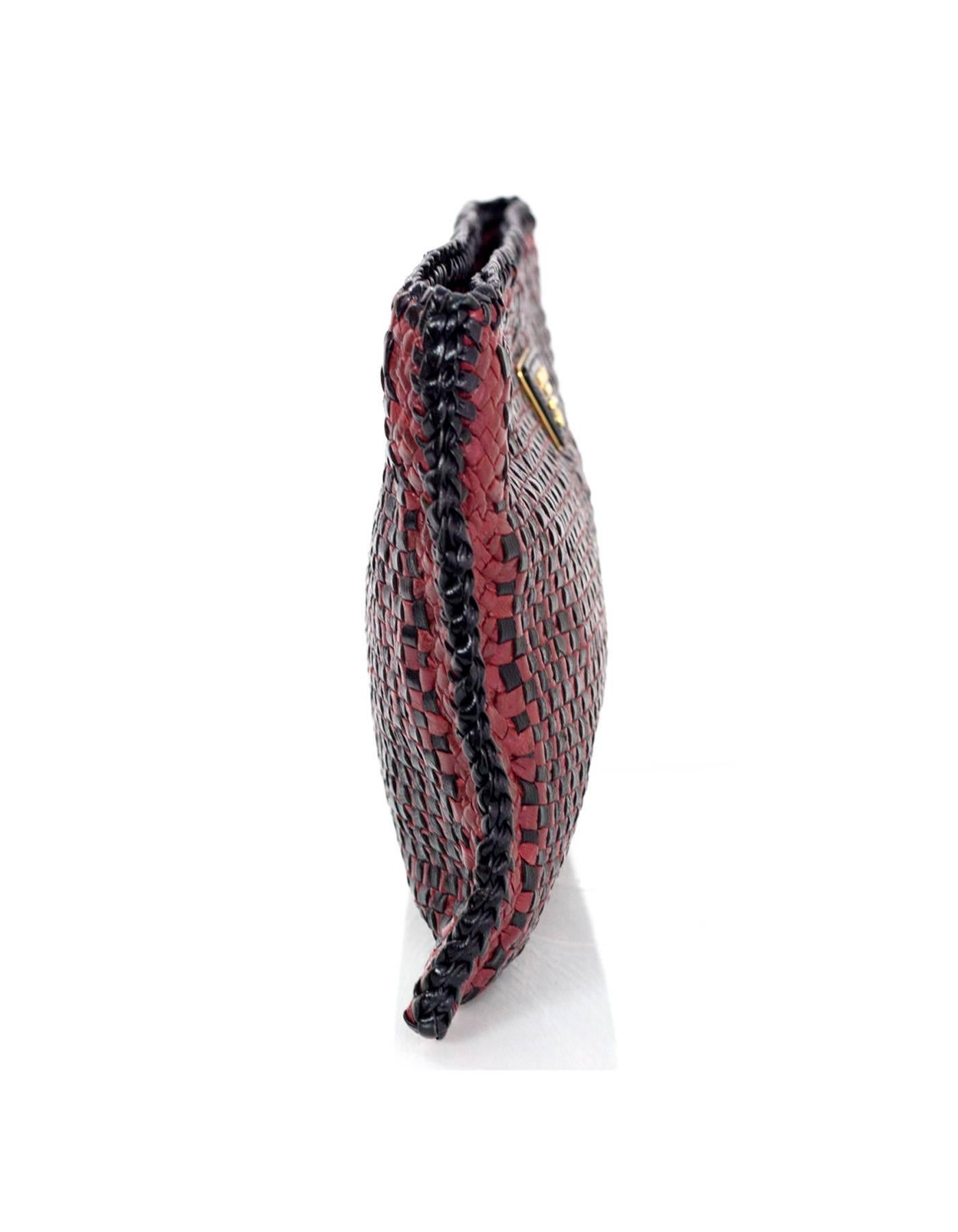 Prada Black & Burgundy Woven Leather Madras Clutch 
Features black leather and goldtone Prada name plate at front

Made In: India
Color: Black and burgundy
Hardware: Goldtone
Materials: Leather
Lining: Beige suede
Closure/Opening: Zip across
