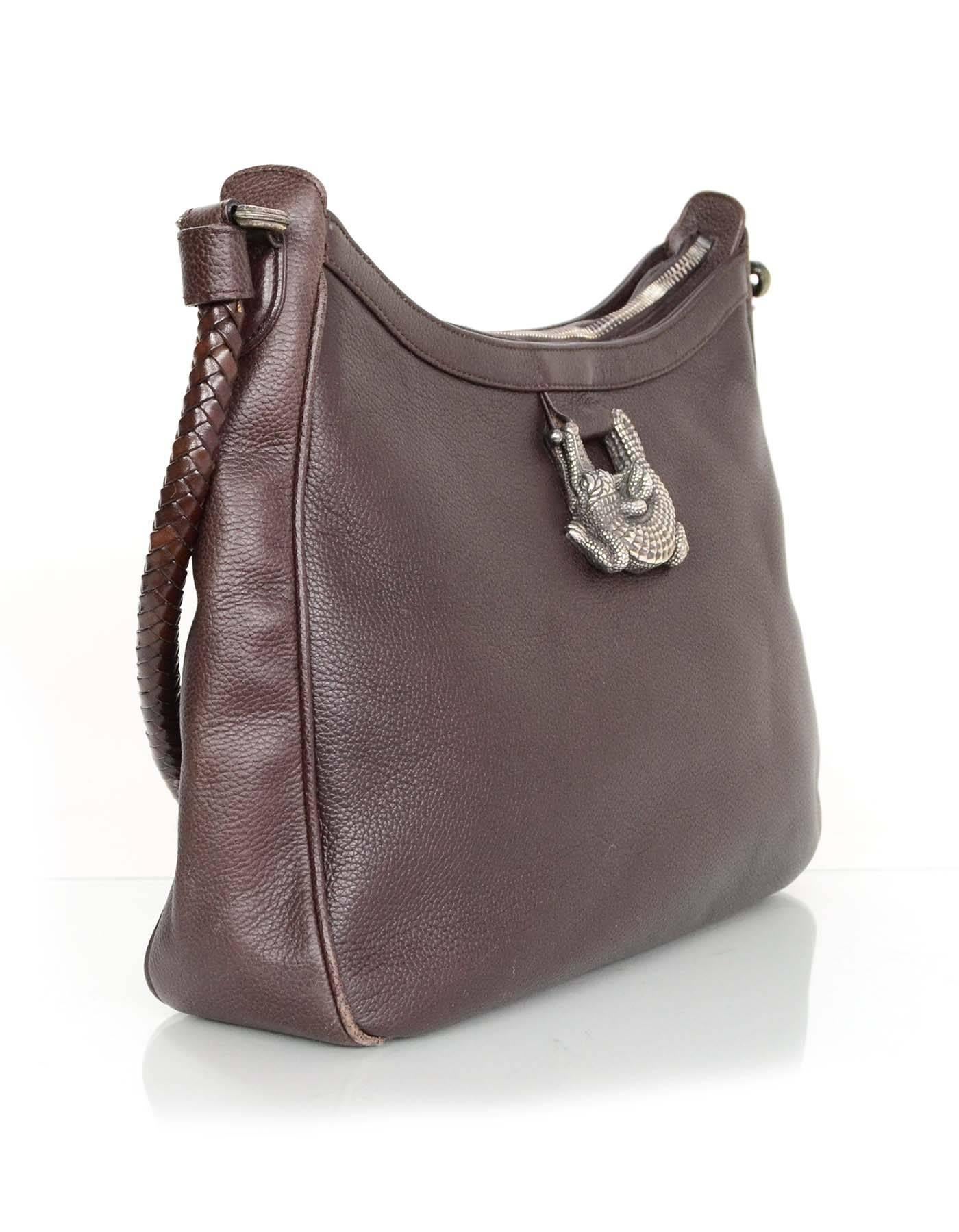 Barry Kieselstein-Cord Brown Leather Shoulder Bag
Features sterling silver hardware

Made In: Itay
Year of Production: 1993
Color: Brown
Hardware: Sterling silver
Materials: Leather and sterling silver
Lining: Green suede
Closure/Opening: Zip across