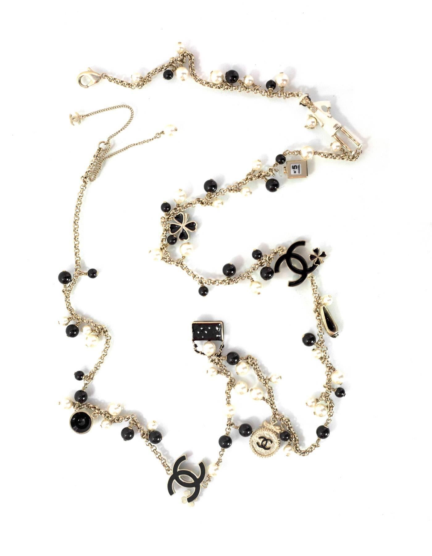Chanel Pearl Beaded & Iconic Charm Necklace
Features Chanel iconic charms throughout necklace
Made In: Italy
Year of Production: 2012
Color: Light gold, black, and ivory
Materials: Faux pearl, beads, metal and enamel
Closure: Lobster claw