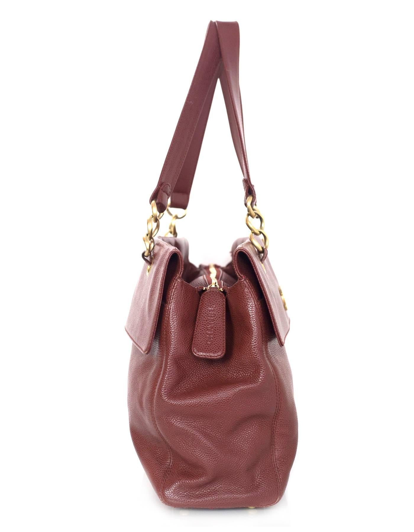 Chanel Burgundy Caviar Tote 
Features goldtone CC pendant on front of bag

Made In: Italy
Year of Production: 2003-2004
Color: Burgundy
Hardware: Goldtone
Materials: Caviar leather
Lining: Burgundy silk-blend fabric
Closure/Opening: Zip across