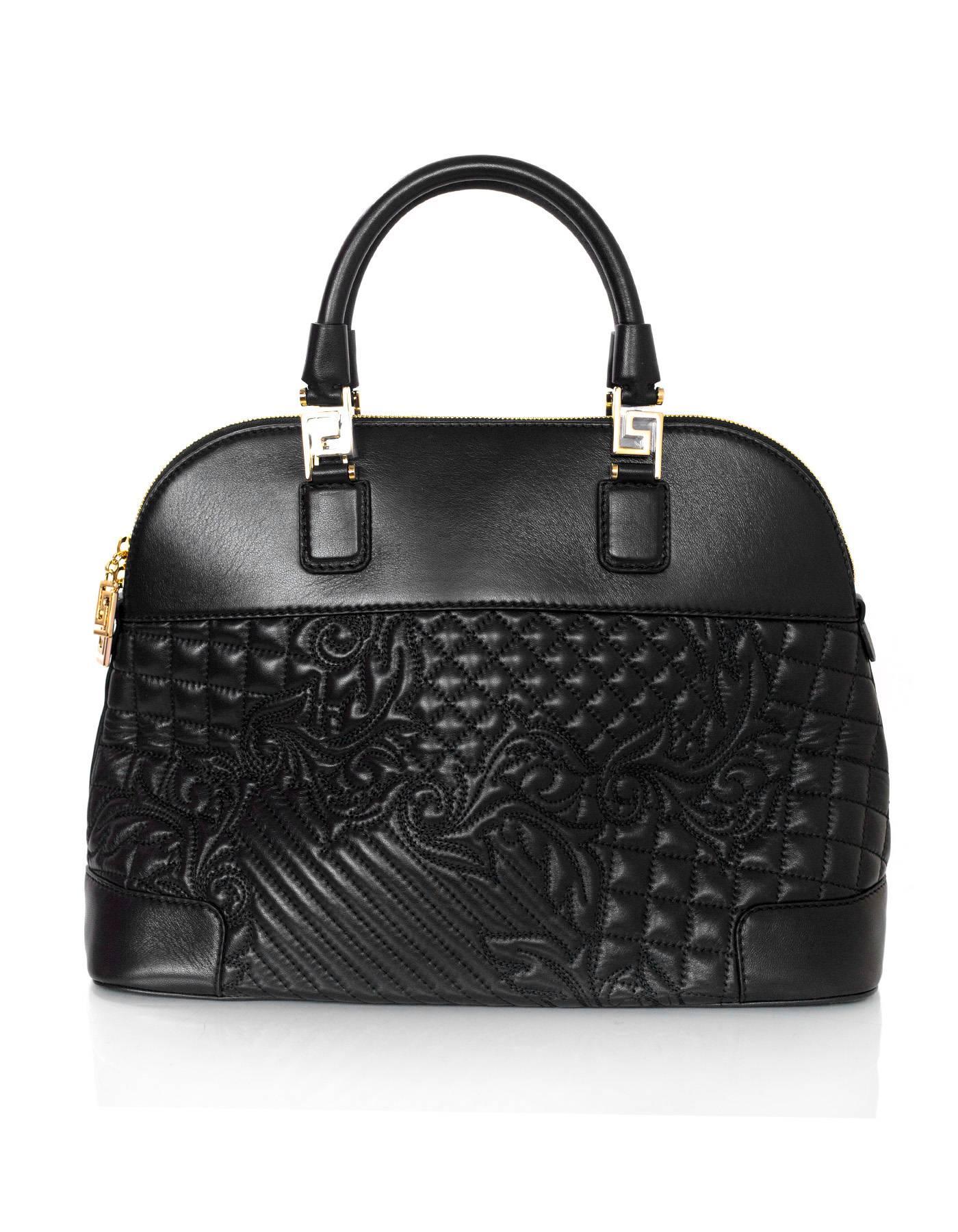 Versace Nappa Athena Barocco Quilted Vanitas Bag 
Features optional shoulder/crossbody strap and detachable Versace logo bag charm

Made In: Italy
Color: Black
Hardware: Pale gold
Materials: Leather
Lining: Brown and yellow printed