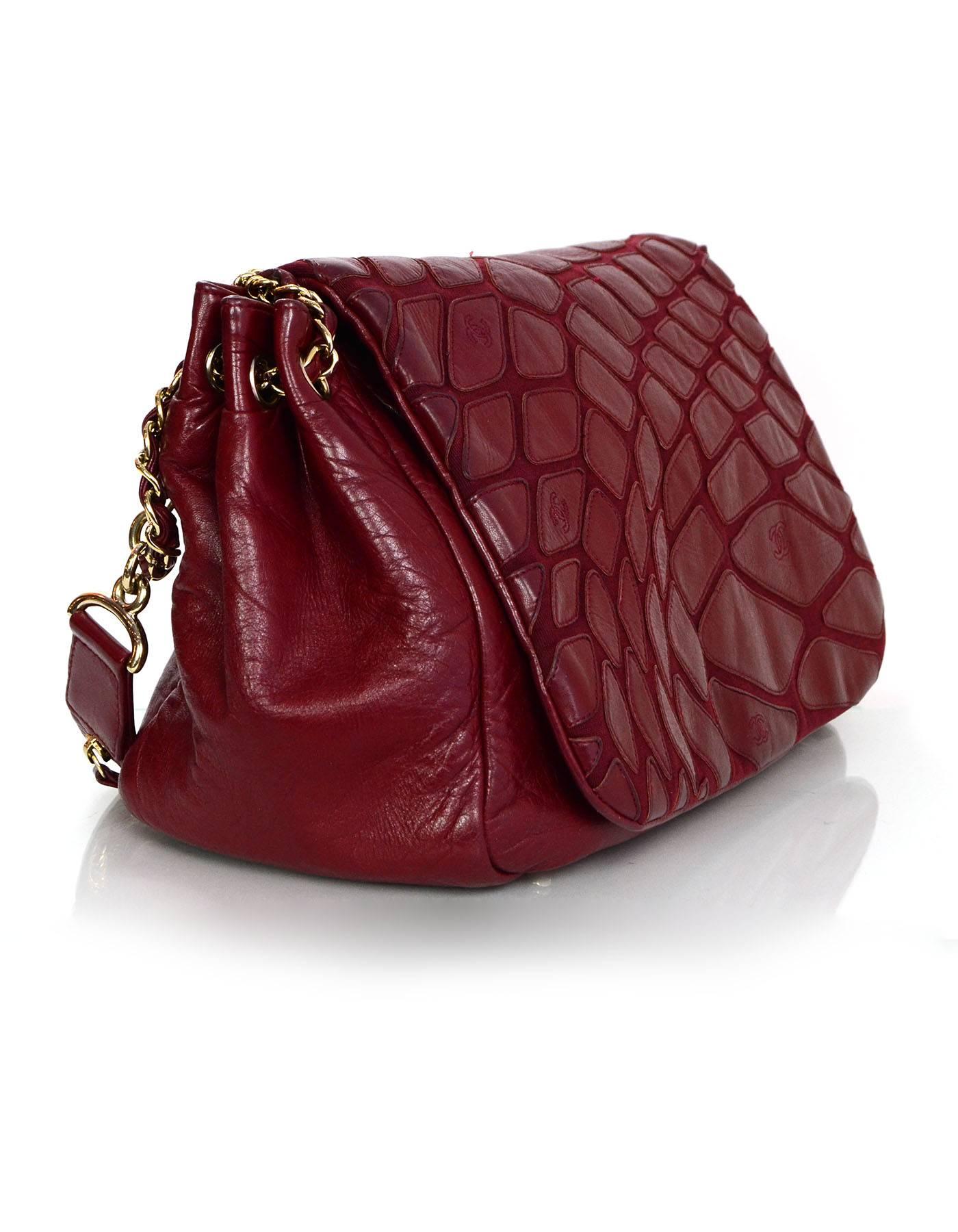 Chanel Red Scales Leather Accordion Flap Bag  
Features CC charm detail at shoulder strap and zipper detailing along shoulder strap

Made In: Italy
Year of Production: 2009
Color: Red
Hardware: Goldtone
Materials: Distressed leather
Lining: Beige