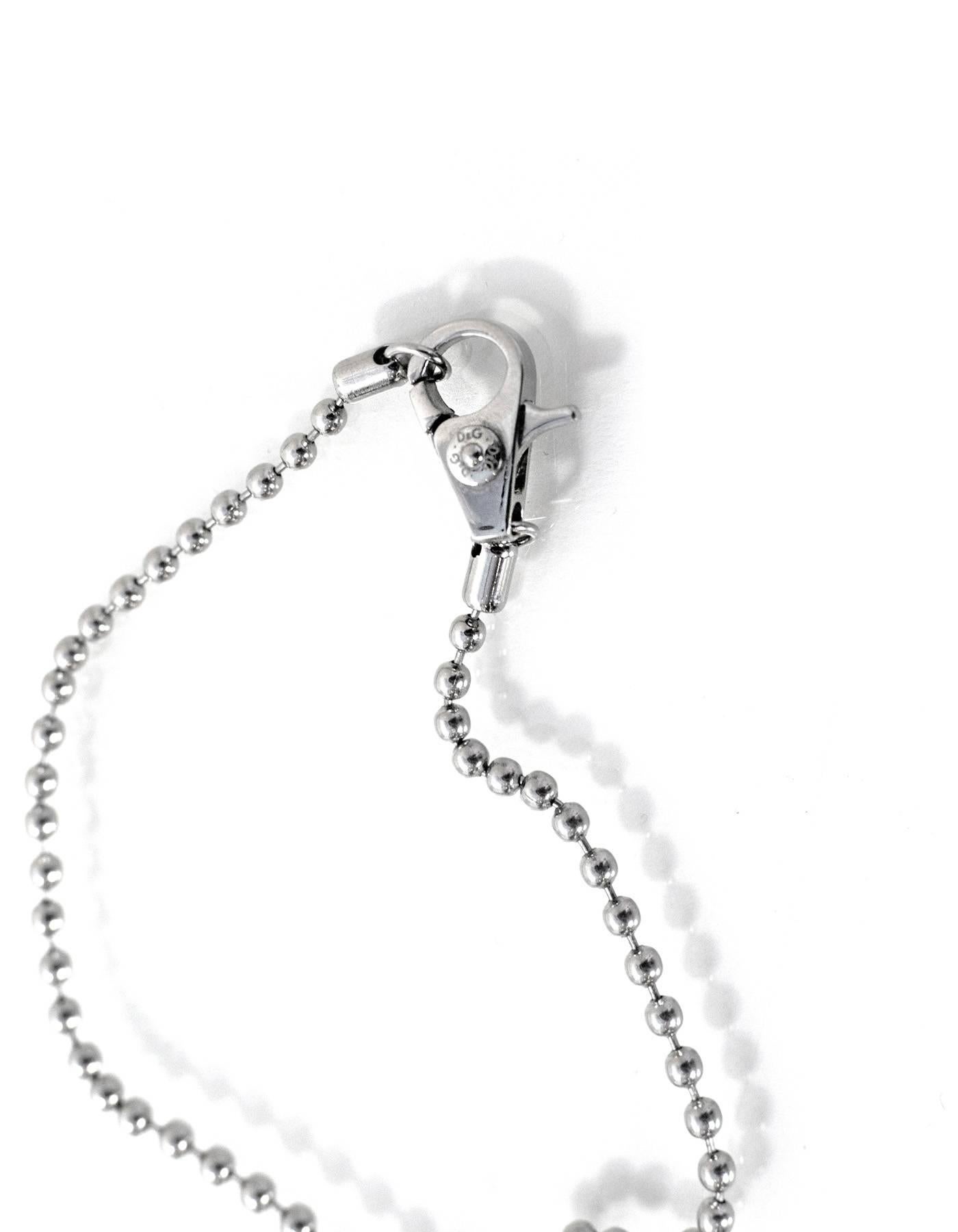 Dolce & Gabbana Silver & White Peace Sign Necklace
Features small screws detailing pendant with D&G stamped and white enamel

Color: Silvertone and white
Materials: Metal and enamel
Closure: Lobster claw clasp
Stamp: D&G
Overall