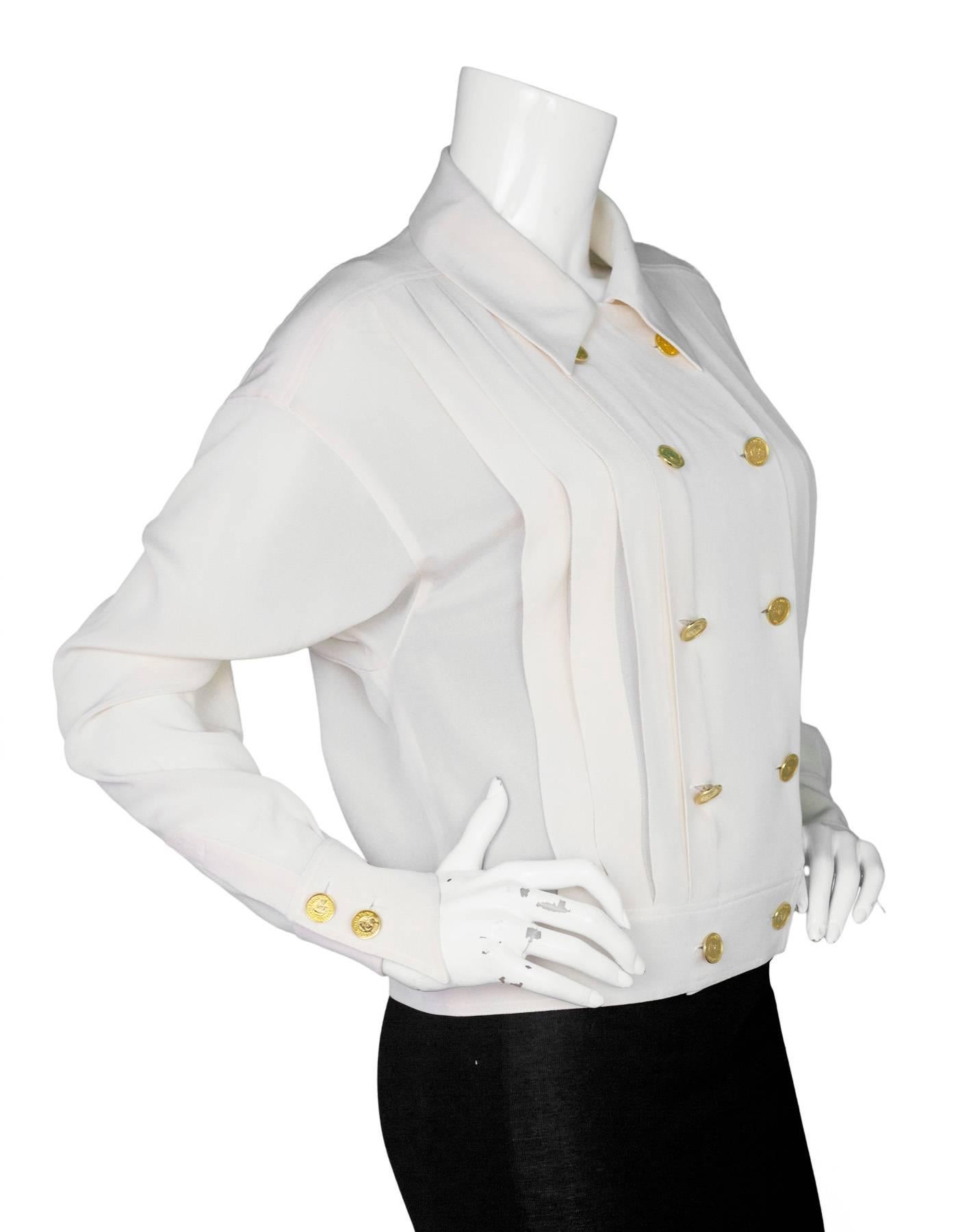 Chanel Vintage Cream Silk Double Breasted Blouse 
Features pleats and gold detailed buttons throughout

Color: Cream
Composition: Not given- believed to be 100% silk
Lining: None
Closure/Opening: Double breasted button down closure
Exterior Pockets: