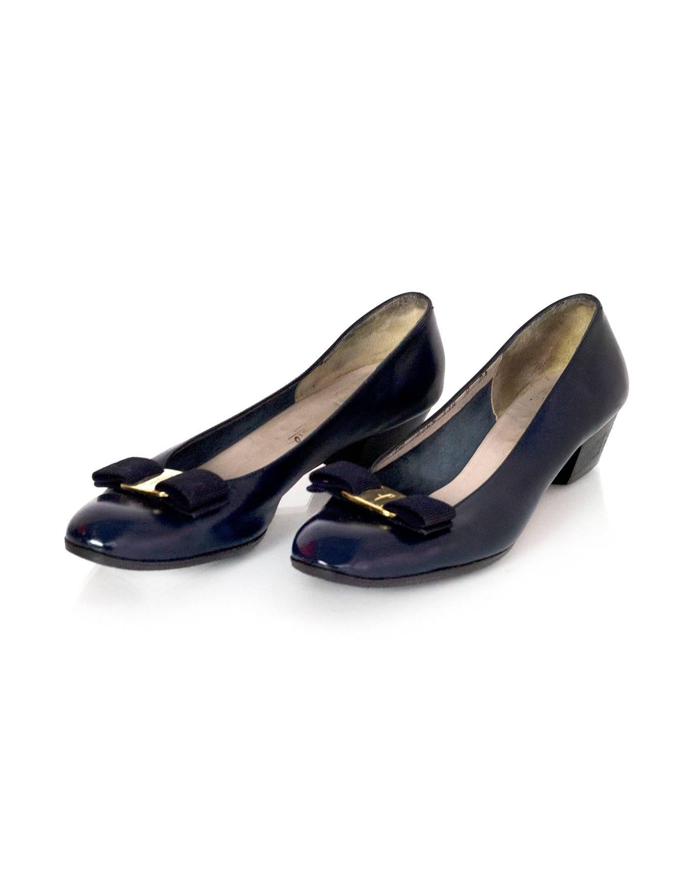 Salvatore Ferragamo Navy Leather Kitten Heels 
Features navy grosgrain and goldtone bow at toe cap

Made In: Italy
Color: Navy
Materials: Leather
Closure/Opening: Slip on
Sole Stamp: Made in Italy
Lining Stamp: DR 22765 338 7 2A
Overall Condition: