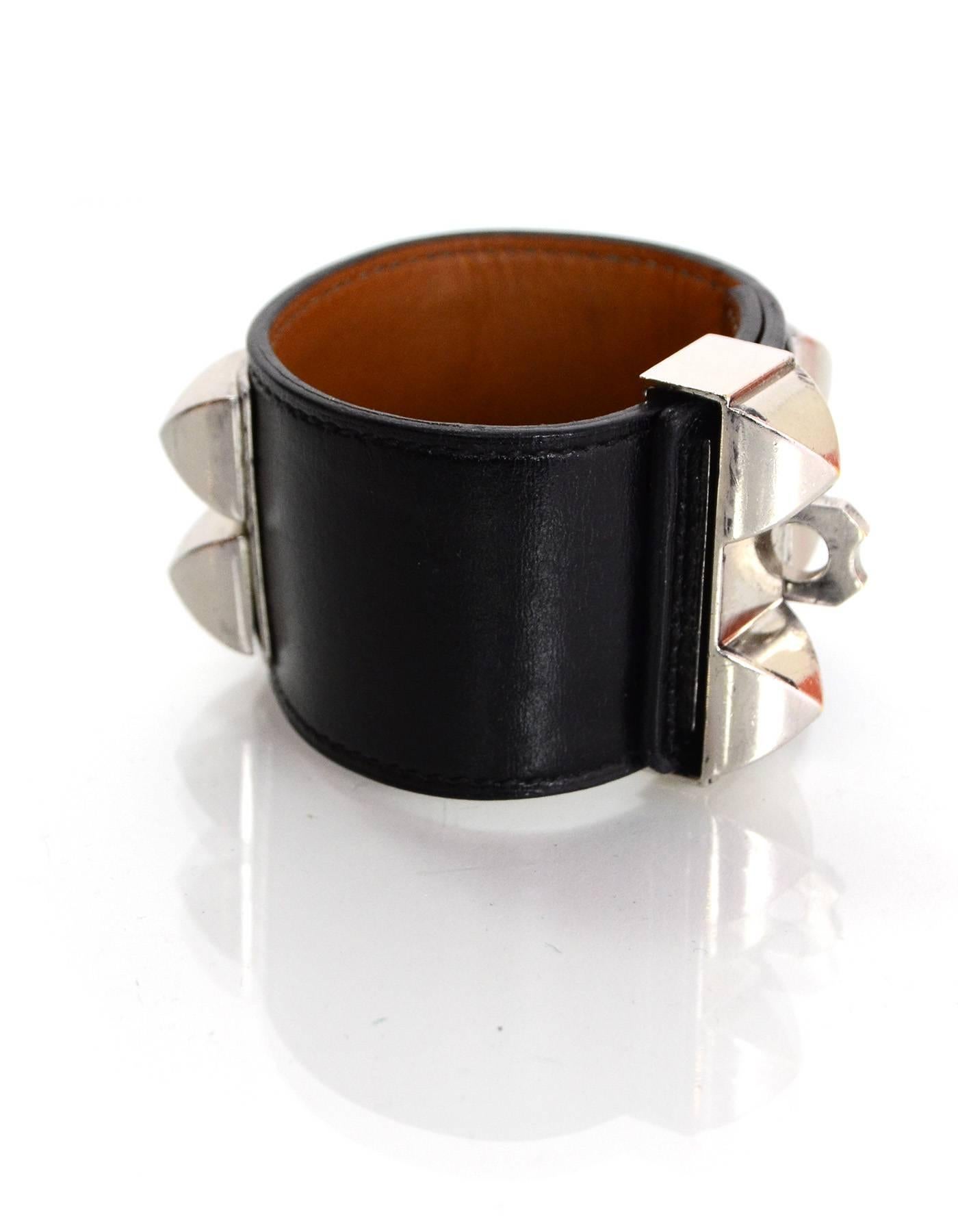 Hermes Black Leather CDC Cuff 

Made In: France
Year of Production: 2013
Color: Black and silver
Hardware: Palladium
Materials: Leather and metal
Closure: Stud and notch closure with sliding bar
Stamp: Q Stamp in square
Overall Condition: Very good