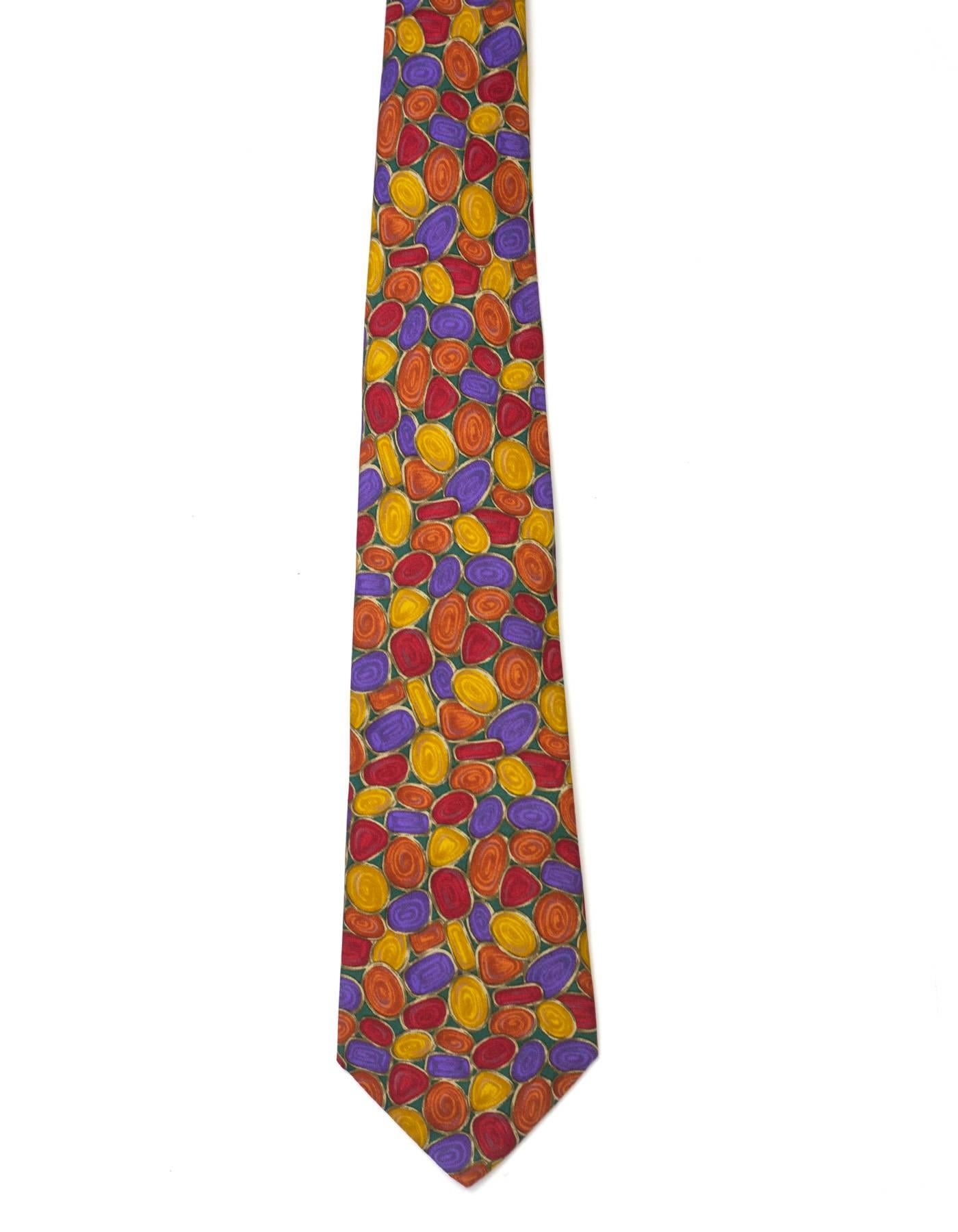 Chanel Multi-Color Jewel Print Silk Tie 

Made In: Italy
Color: Red, orange, yellow, purple, and green
Composition: 100% silk
Overall Condition: Excellent pre-owned condition
Measurements: 
Length: 57"
Width: 1.75"-3.65"
