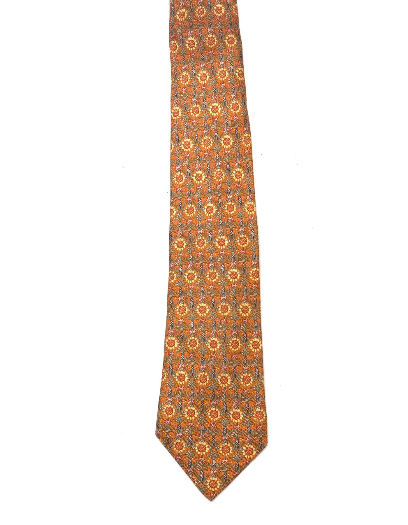 Hermes Orange Sunflower Print Silk Tie 

Made In: France
Color: Orange, yelow and green
Composition: 100% silk
Overall Condition: Excellent pre-owned condition
Measurements: 
Length: 58.25"
Width: 2"-3.75"