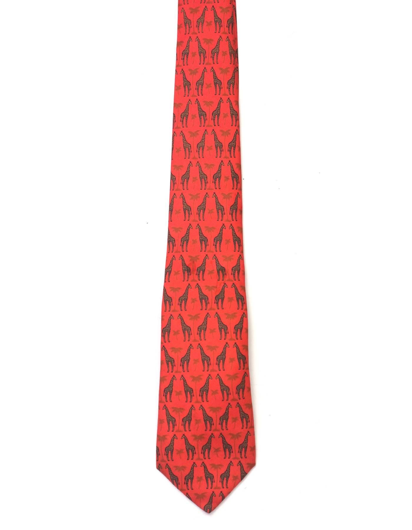 Hermes Orange Giraffe Print Silk Tie 
Features giraffes and palm trees printed throughout

Made In: France
Color: Orange and black
Composition: 100% silk
Overall Condition: Excellent pre-owned condition
Measurements: 
Length: 57"
Width:
