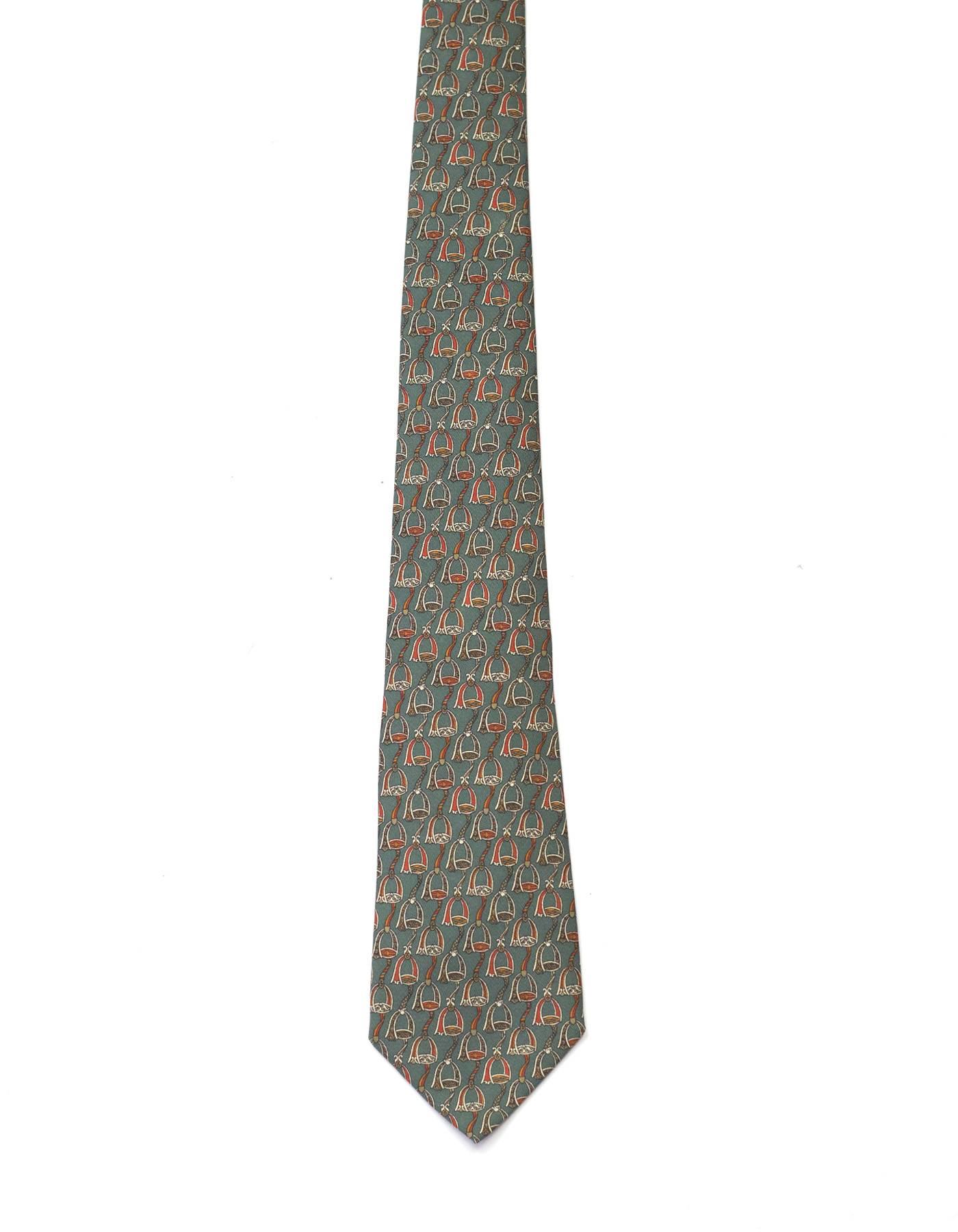 Salvatore Ferragamo Green Stirrup Print Silk Tie 
Features beige ribbon printed toward bottom of tie with logo printed on top

Made In: Italy
Color: Olive green, grey and burgundy
Composition: 100% silk
Overall Condition: Excellent pre-owned