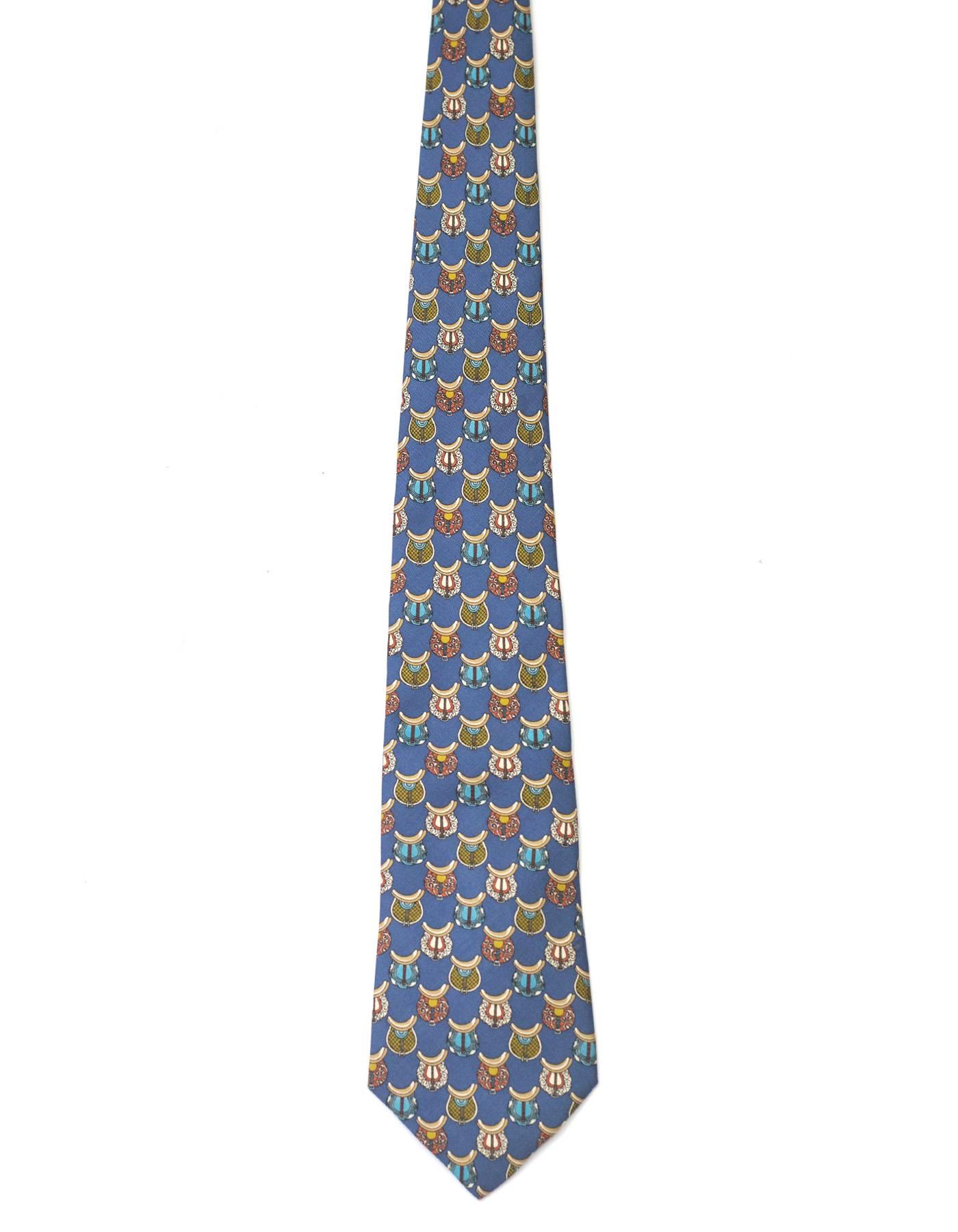 Salvatore Ferragamo Blue Saddle Print Silk Tie
Features different colored and patterend saddles printed throughout

Made In: Italy
Color: Blue and multi-colored
Composition: 100% silk
Overall Condition: Excellent pre-owned condition 
Measurements: