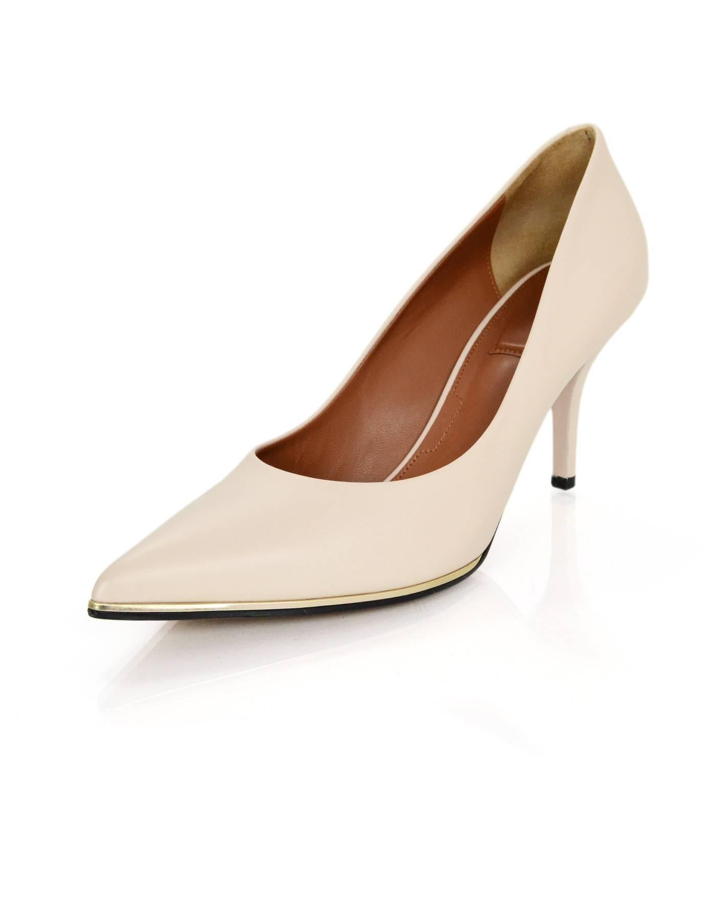 Givenchy Nude Leather Pointed Toe Pumps
Features gold trim at base of shoe

Made In: Italy
Color: Nude
Materials: Leather
Closure: Slide on
Sole Stamp: Givenchy Paris Made in Italy 39
Retail Price: $650 + tax
Overall Condition: Excellent pre-owned