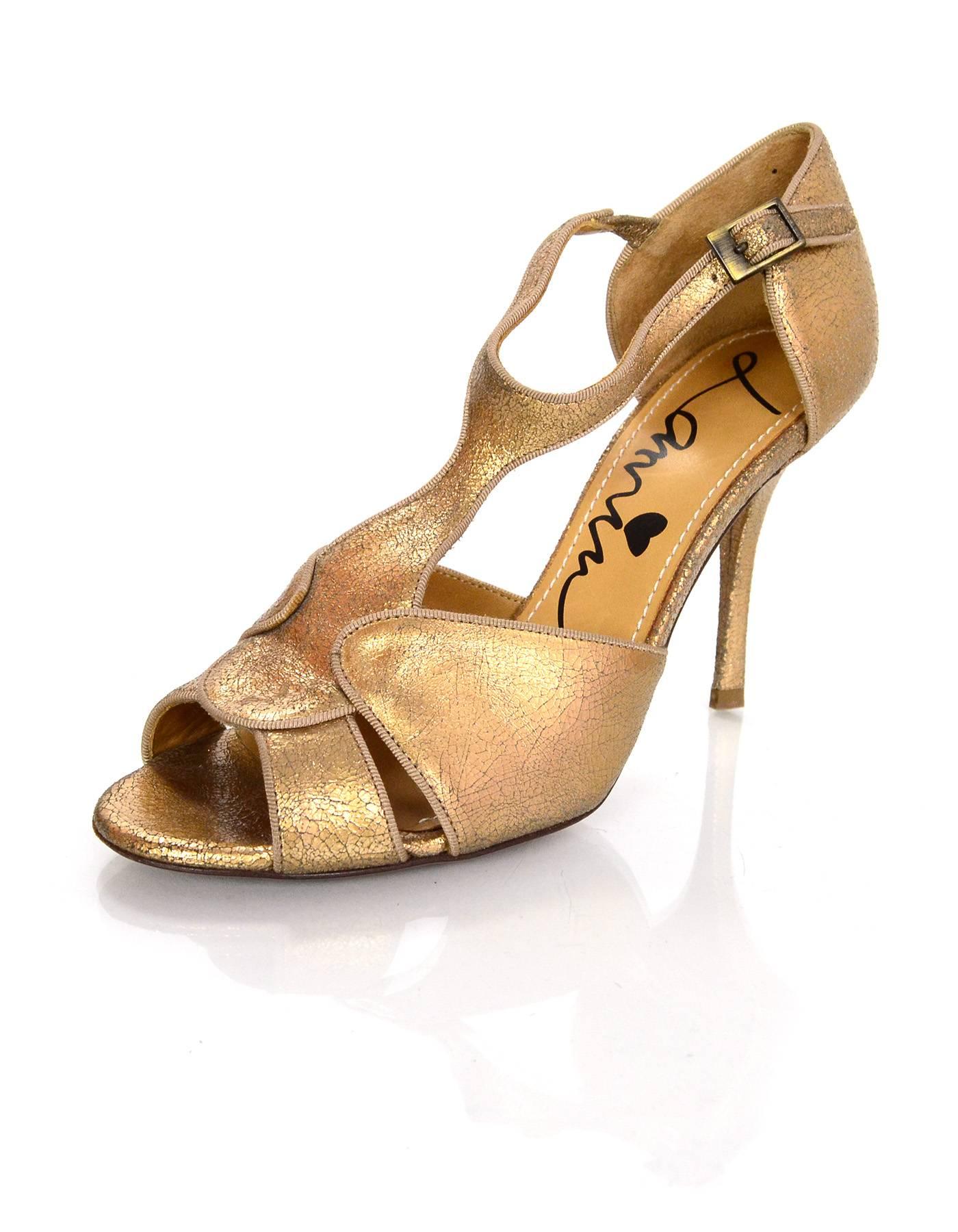 Lanvin Gold Distressed T-Strap Sandals
Features distressed crackle effect throughout

Made In: Italy
Color: Gold
Materials: Distressed leather
Closure/Opening: Ankle strap with buckle and notch closure
Sole Stamp: Vero Cuoio Made in Italy38
Overall