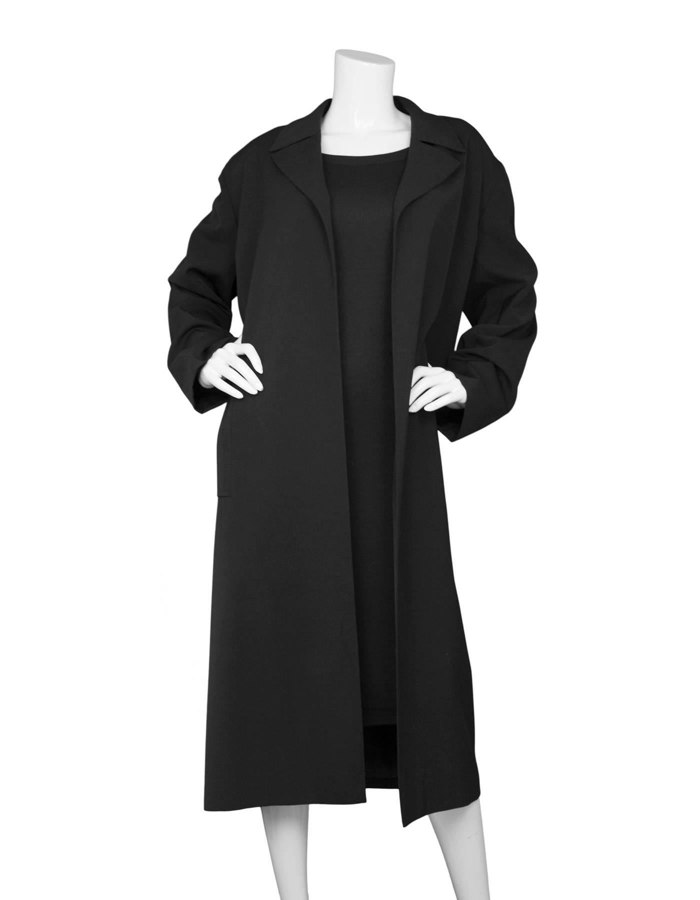 Chanel Black Open Front Trench Coat 
*Note: Non-Chanel waist belt has been added*

Made In: France
Year of Production: 1996
Color: Black
Composition: 100% wool
Lining: Black, 100% silk
Closure/Opening: Open front with added waist belt
Exterior