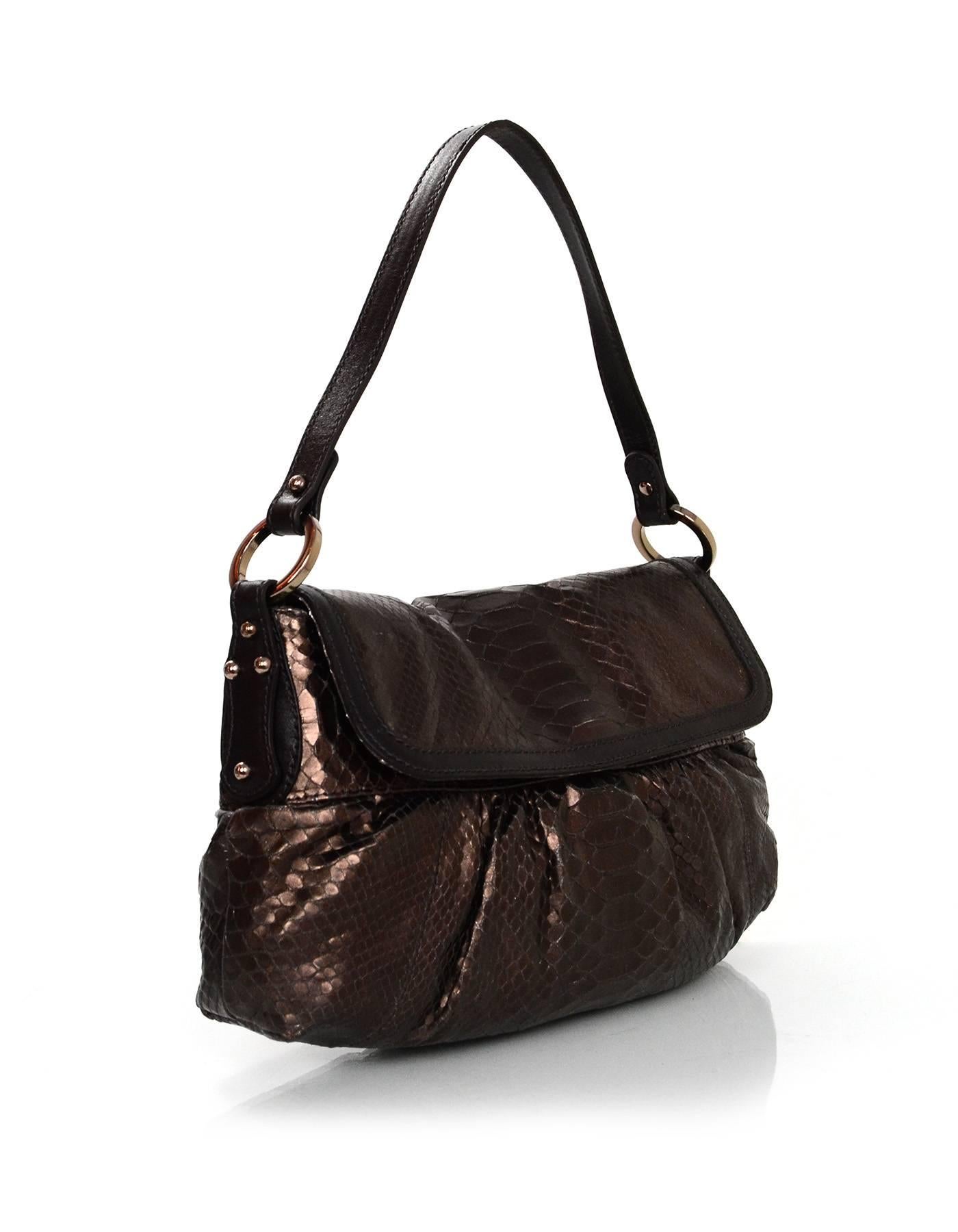 Fendi Bronze Embossed Python Chef Baguette
Features brown leather trim through exterior

Made In: Italy
Color: Bronze and brown
Hardware: Rose gold/bronze
Materials: Leather
Lining: Brown nylon
Closure/Opening: Flap top with magnetic snap