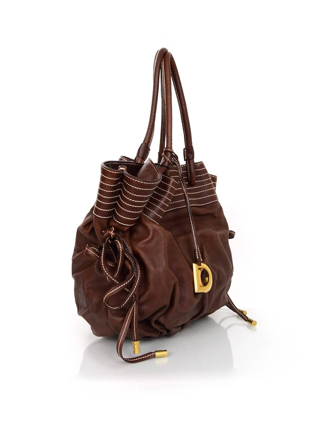 Dolce & Gabbana NEW Brown Leather Drawstring Bag
Features removable D & G bag charm and contrast white stitching

Made In: Italy
Color: Brown
Hardware: Goldtone 
Materials: Leather
Lining: Red canvas
Closure/Opening: Side drawstring