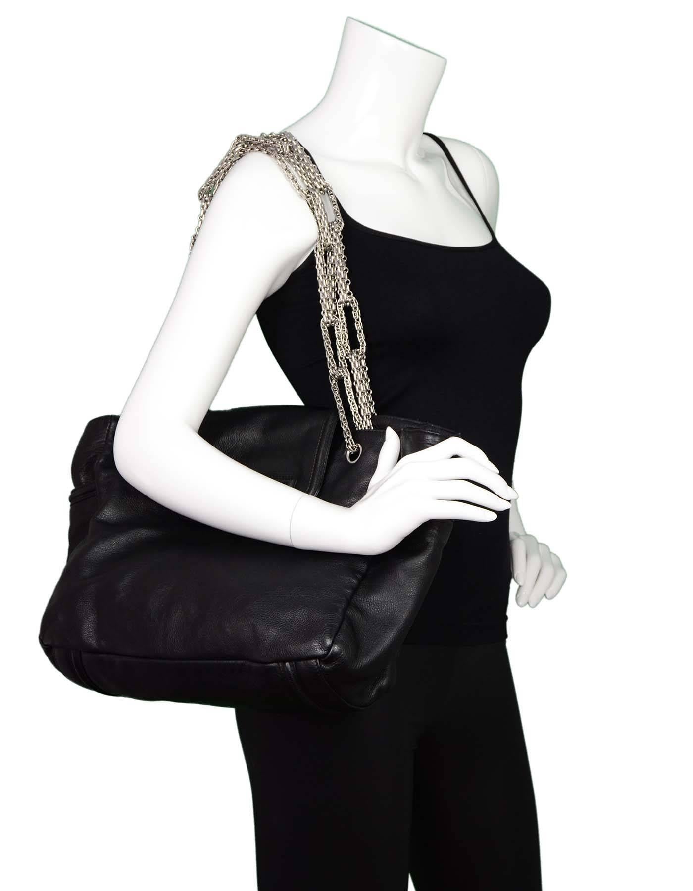 Chanel Black Leather 2.55 Reissue Lock Tote
Features large reissue twist lock at front and heavy mademoiselle chain link straps

Made In: Italy
Year of Production: 2008
Color: Black
Hardware: Silvertone
Materials: Leather, metal
Lining: Grey