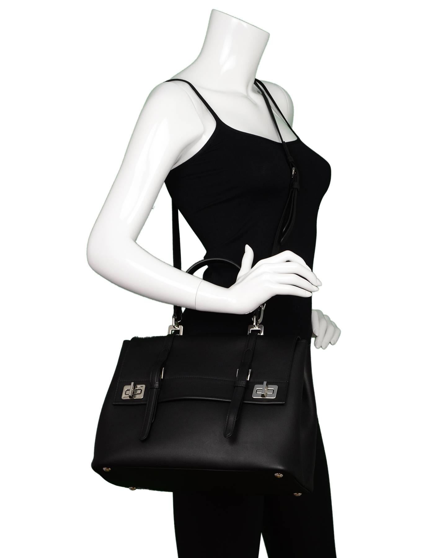 Prada Black Pattina City Calf Satchel Bag
Features optional shoulder strap

Made In: Italy
Color: Black, silver
Hardware: Silvertone
Materials: Calfskin leather, metal
Lining: Black leather
Closure/Opening: Flap top with two twist lock