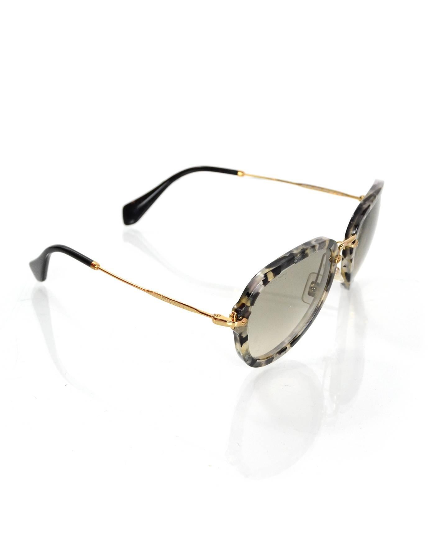 Miu Miu Black and Grey Tortoise Sunglasses

Features aviator style with goldtone wire arms

 Made In: Italy
Color: Black, grey, gold
Materials: Resin, metal
Stamp: Miu Miu Made in Italy 
Overall Condition: Excellent pre-owned condition with the