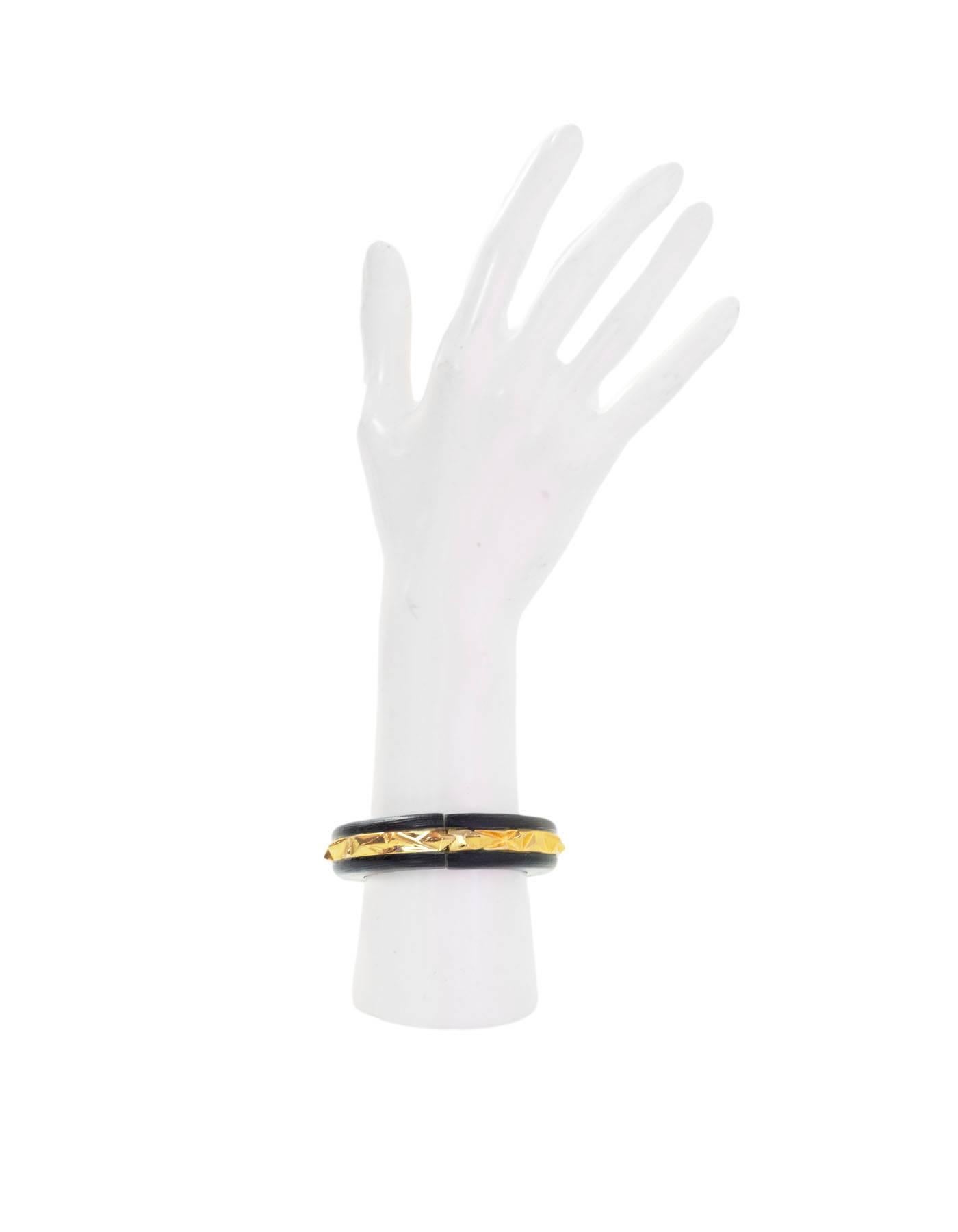 Alexis Bittar Lucite and Goldtone Bangle

Color: Black, gold
Materials: Resin and metal
Closure: Magnetic closure
Stamp: Alexis Bittar
Retail Price: $225 + tax
Overall Condition: Excellent pre-owned condition with the exception of light surface