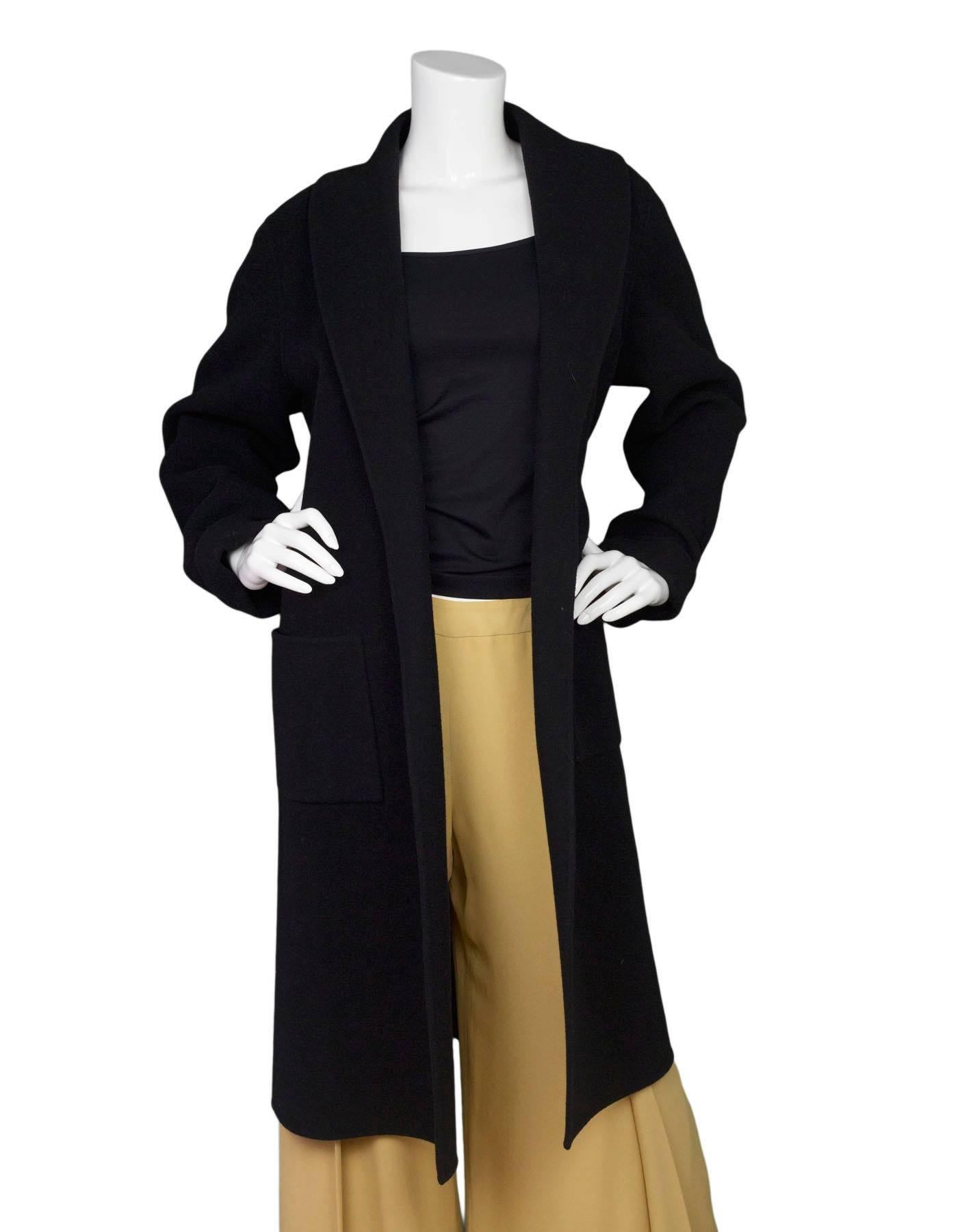 Eileen Fisher Black Draped Coat Sz L

Made In: China
Color: Black
Materials: not listed, feels like cashmere/wool blend
Lining: None
Closure/Opening: None
Exterior Pockets: Front hip pockets
Interior Pockets: None
Overall Condition: Excellent