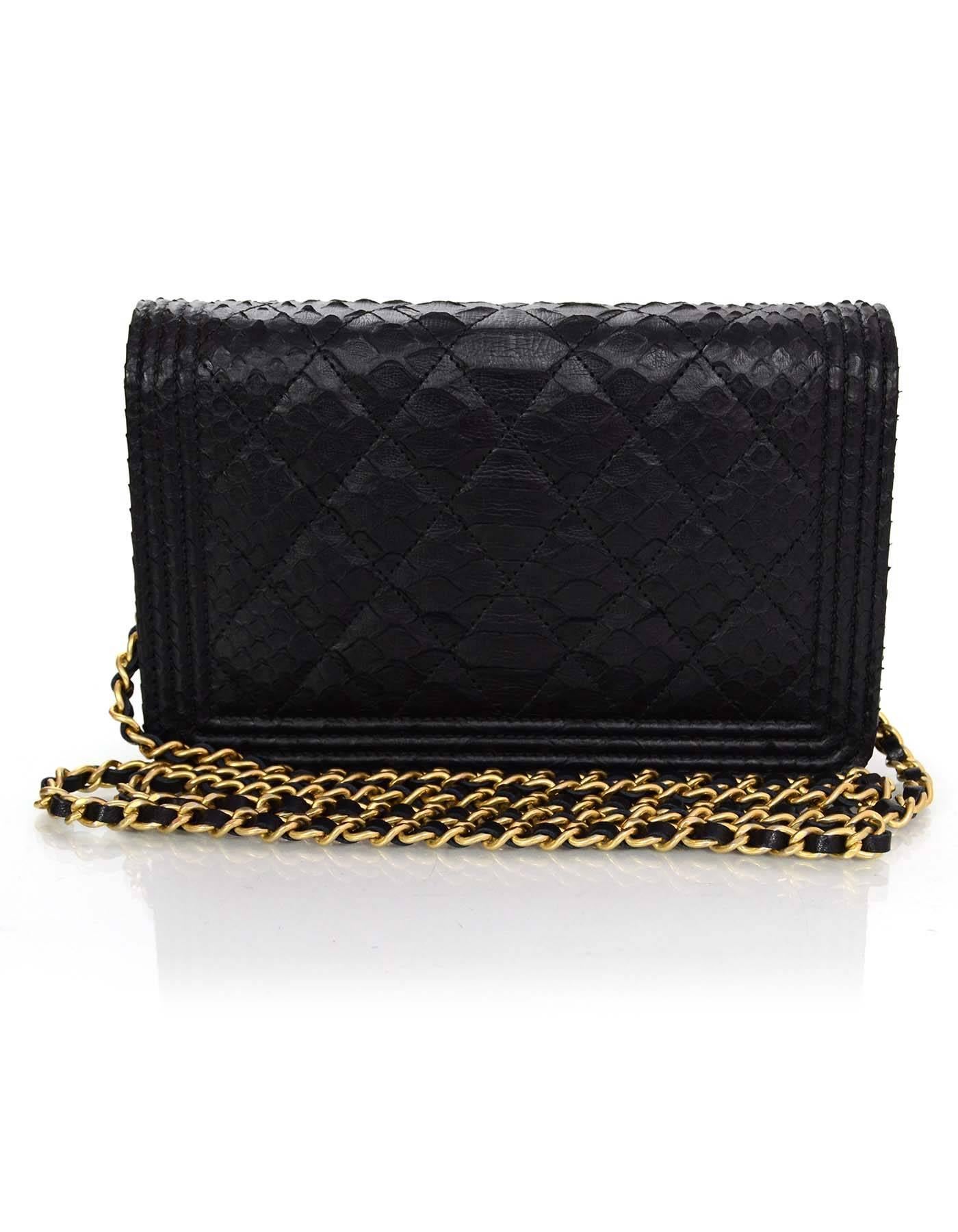 Chanel NEW '17 Black Python Boy WOC Bag

Made In: Italy
Year of Production: 2017
Color: Black
Hardware: Goldtone
Materials: Python 
Lining: Black leather and grosgrain
Closure/Opening: Flap top with magnetic snap closure
Exterior Pockets: