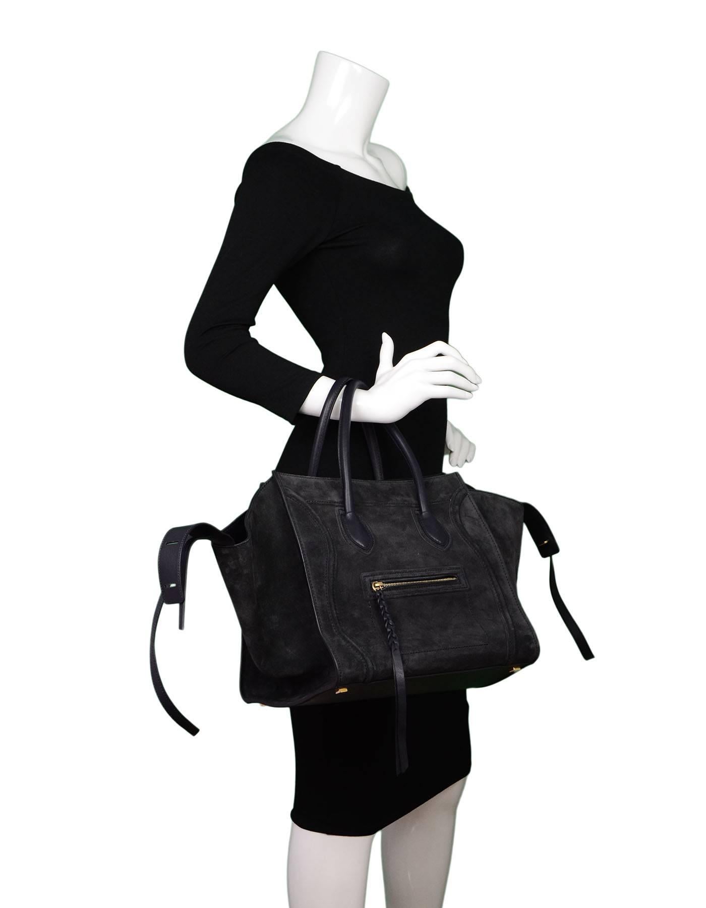 Celine Medium Midnight Suede Phantom Tote

Made In: Italy
Color: Midnight, dark blue
Hardware: Goldtone
Materials: Suede, leather
Lining: Leather
Closure/Opening: Open top with center tassel closure
Exterior Pockets: One front zipper pocket
Interior