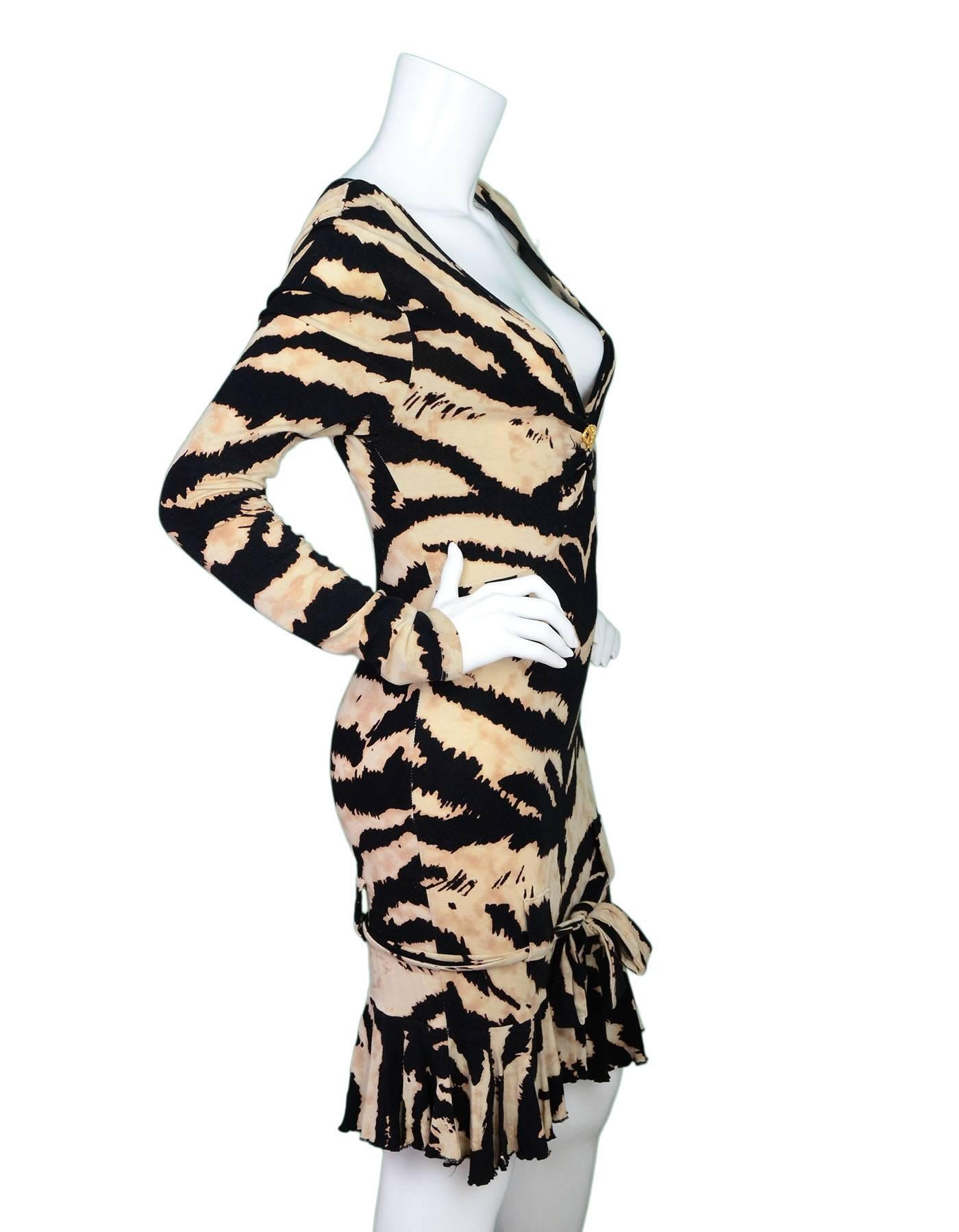 Roberto Cavalli Tiger Print Long Sleeve Dress 
Features plunging neckline with goldtone and crystal serpent charm as well as ruffles at hemline

Made In: Italy
Color: Black, brown and tan
Composition: 94% viscose, 6% elastane
Lining: