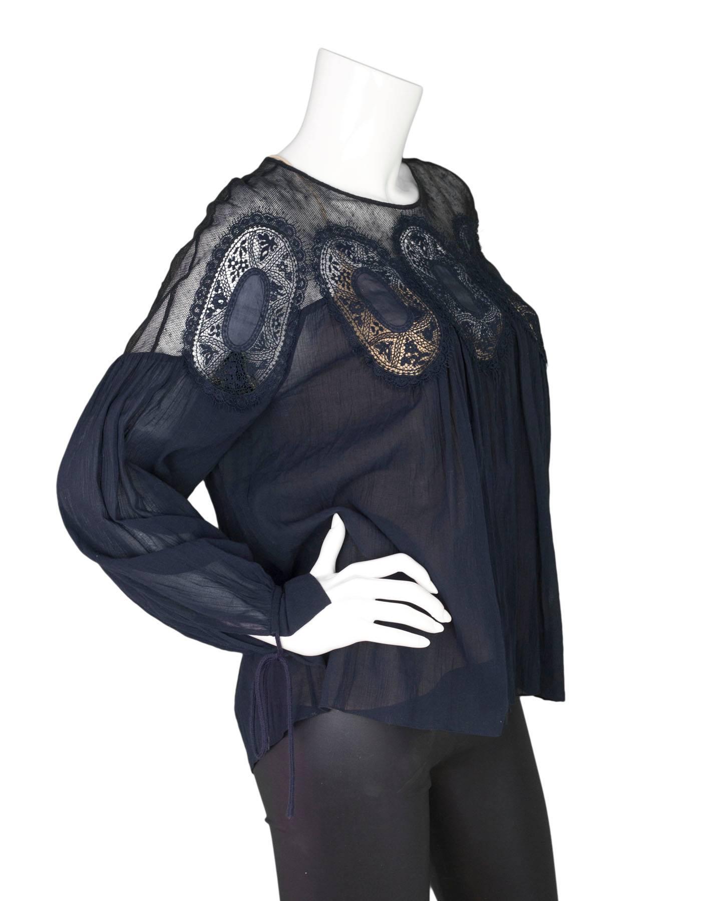 Chloe Navy Cotton & Lace Parachute Blouse
Features lace at yoke of blouse and ties at sleeves

Made In: Madagascar
Color: Navy
Composition: Body- 100% cotton, Lace Yoke- 65% linen, 35% polyamide
Lining: Nude Slip Cami- 100% silk
Closure/Opening: