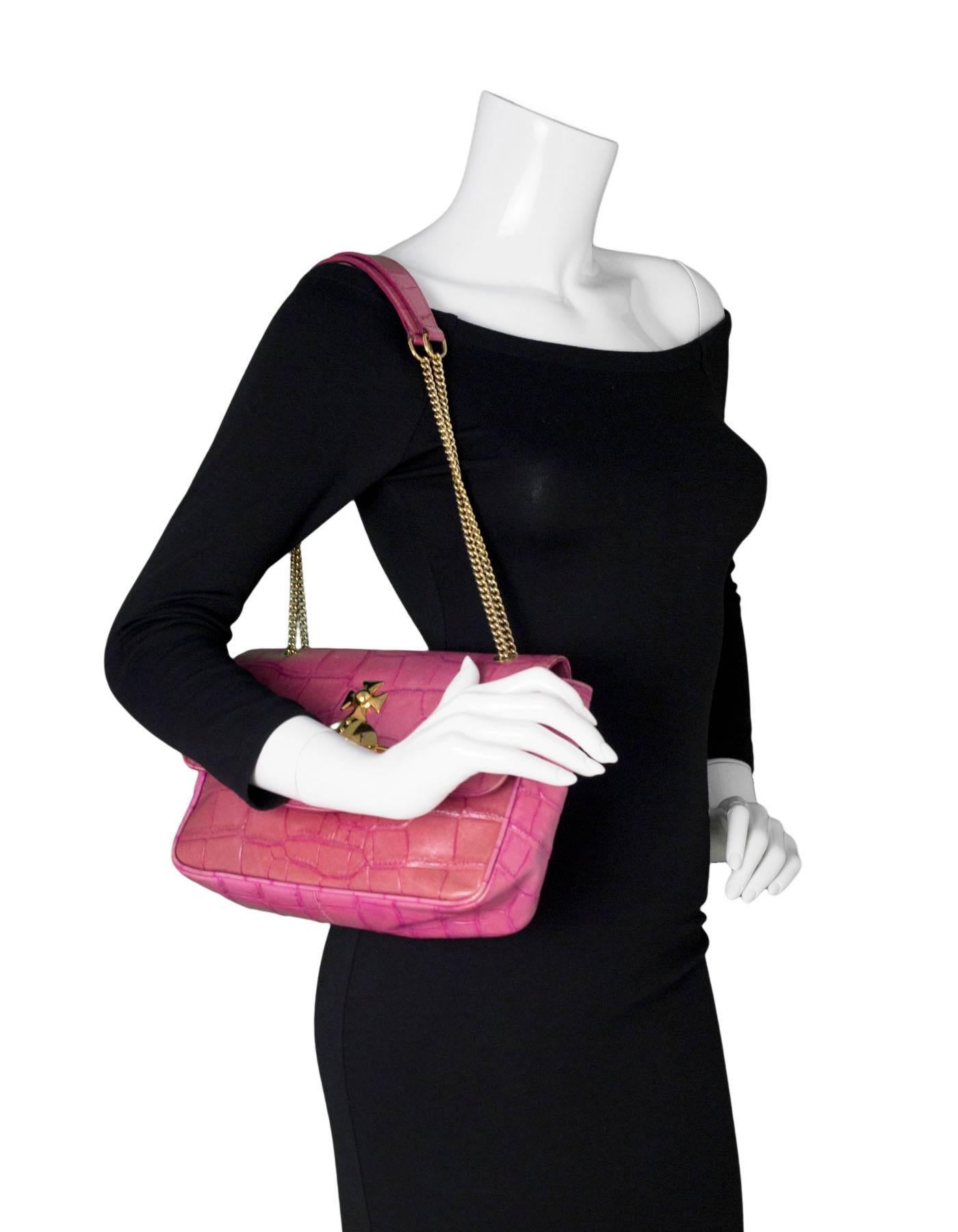 Vivienne Westwood Pink Embossed Shoulder Bag

Features embossed crocdile, goldtone saturn ornament at flap

Made In: Italy
Color: Pink, gold
Hardware: Goldtone
Materials: Leather, metal
Lining: Black and grey textile
Closure/Opening: Flap top with