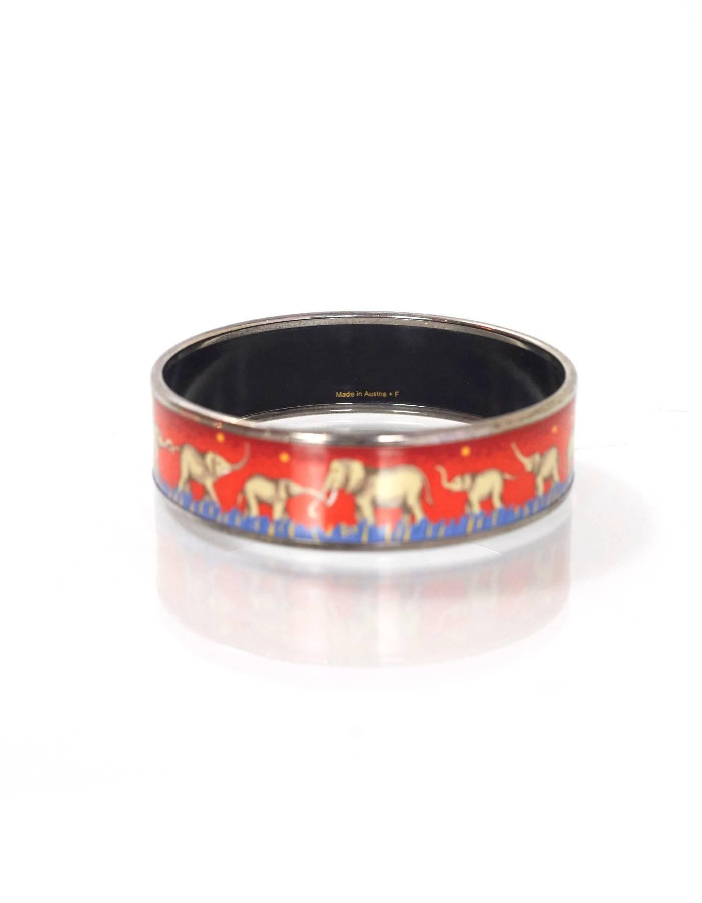Hermes Elephant Enamel Bracelet Sz 65

Made In: Austria
Color: Red, blue
Hardware: Palladium
Materials: Enamel and metal
Closure: None
Stamp: Made in Austria + F
Overall Condition: Excellent good pre-owned condition with the exception of light