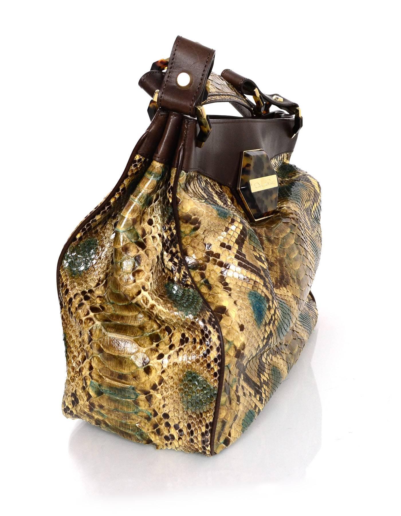 Oscar De La Renta Multi-Colored Python Shoulder Bag
Features soft brown leather trim throughout exterior

Made In: Italy
Color: Brown, green, tan, and beige
Materials: Leather and python
Hardware: Goldtone
Lining: Brown canvas
Closure/Opening: Open