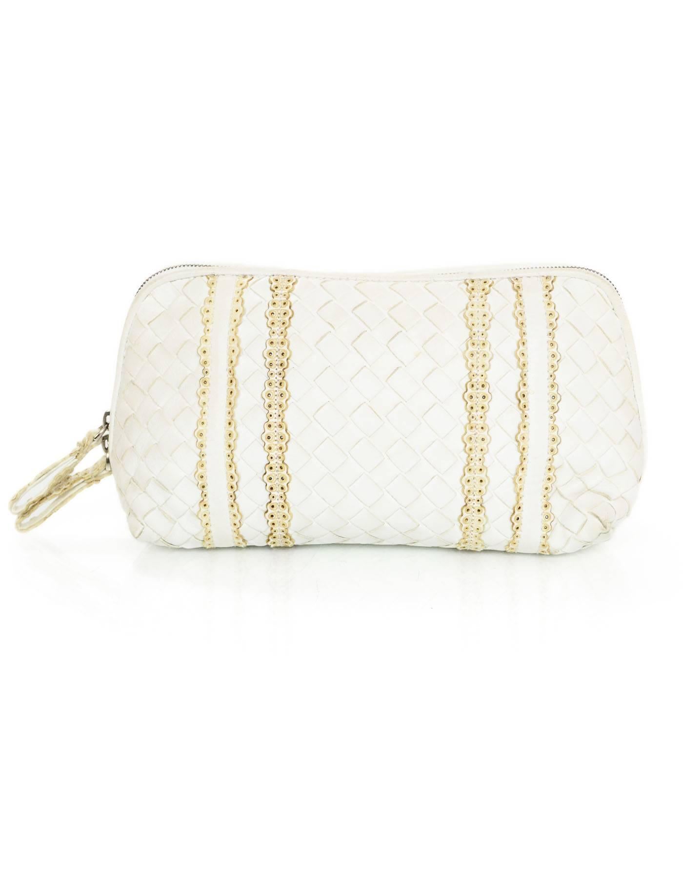 Bottega Veneta White Intrecciato Cosmetic Bag
Features perforated leather trim

Made In: Italy
Color: White, tan
Hardware: Silvertone zipper
Materials: Leather, metal
Lining: Tan textile
Closure/Opening: Double zip top
Overall Condition: Very good