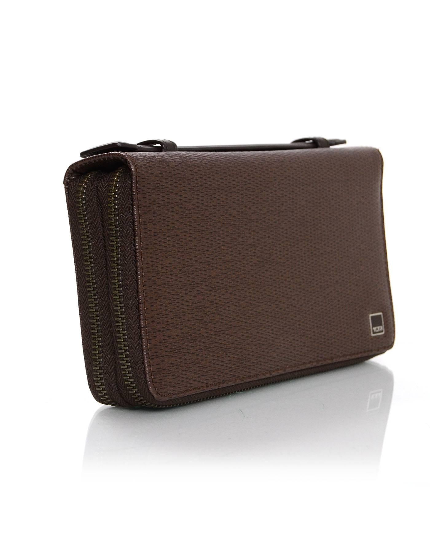 Features multiple compartments for easy access to travel documents and handle at side - Ideal to hold two traveler's belongings

Color: Brown
Hardware: Gunmetal
Materials: Coated canvas, leather, metal
Lining: Brown leather and