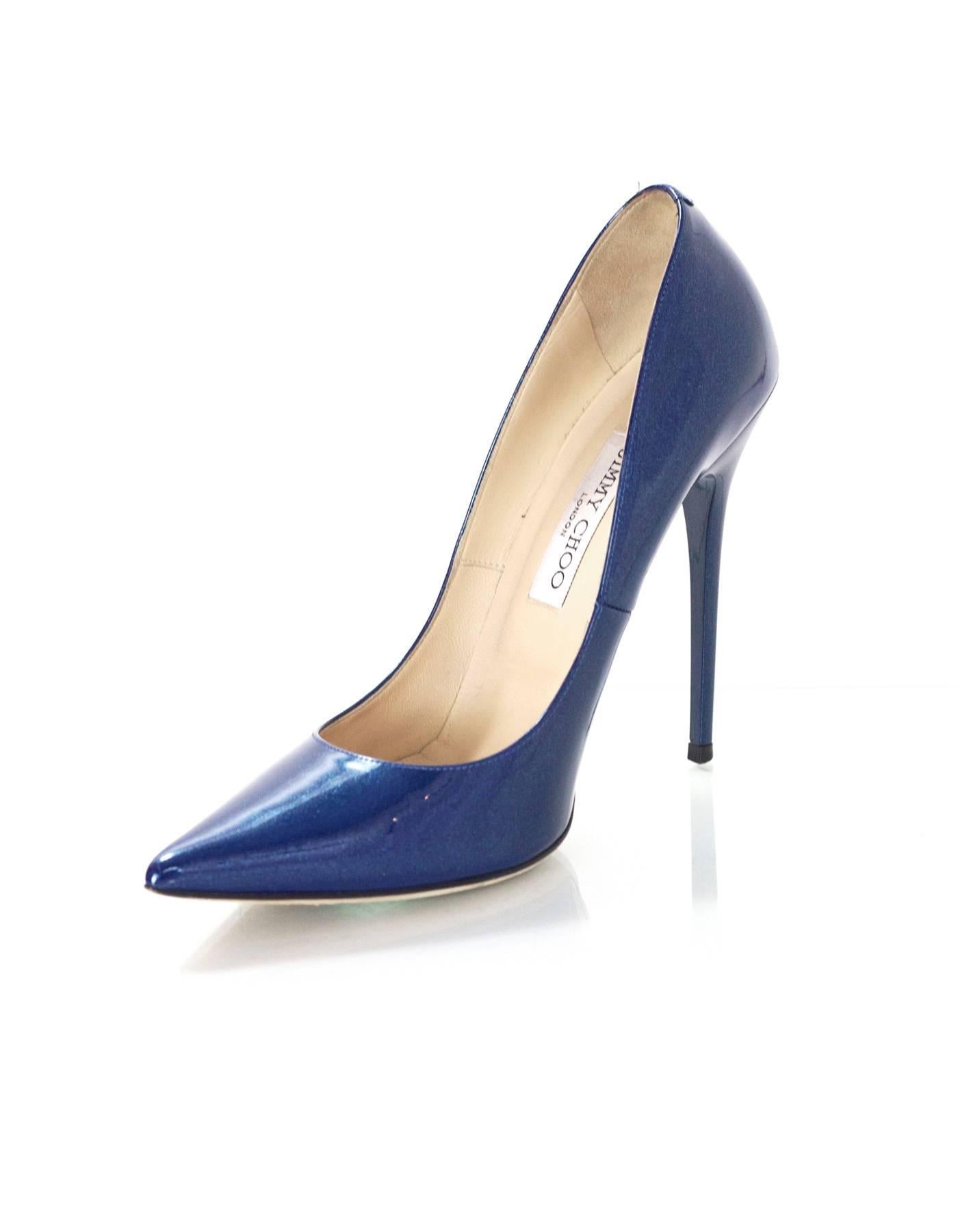 Jimmy Choo Blue Patent Glitter Leather Pumps Sz 39.5

Made In: Italy
Color: Blue
Materials: Patent leather
Closure/Opening: Slide on
Sole Stamp: Jimmy Choo London Made in Italy 39.5
Overall Condition: Excellent pre-owned condition with the exception