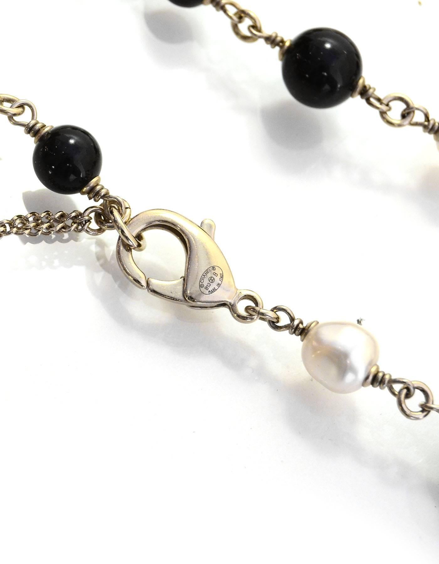 Chanel Black & Ivory Beaded CC Necklace
Features small and large black enamel CC pendants

Made In: Italy
Year of Production: 2013
Color: Black, Ivory and pale goldtone
Hardware: Goldtone
Materials: Metal, faux pearl, and beads
Closure: Lobster claw