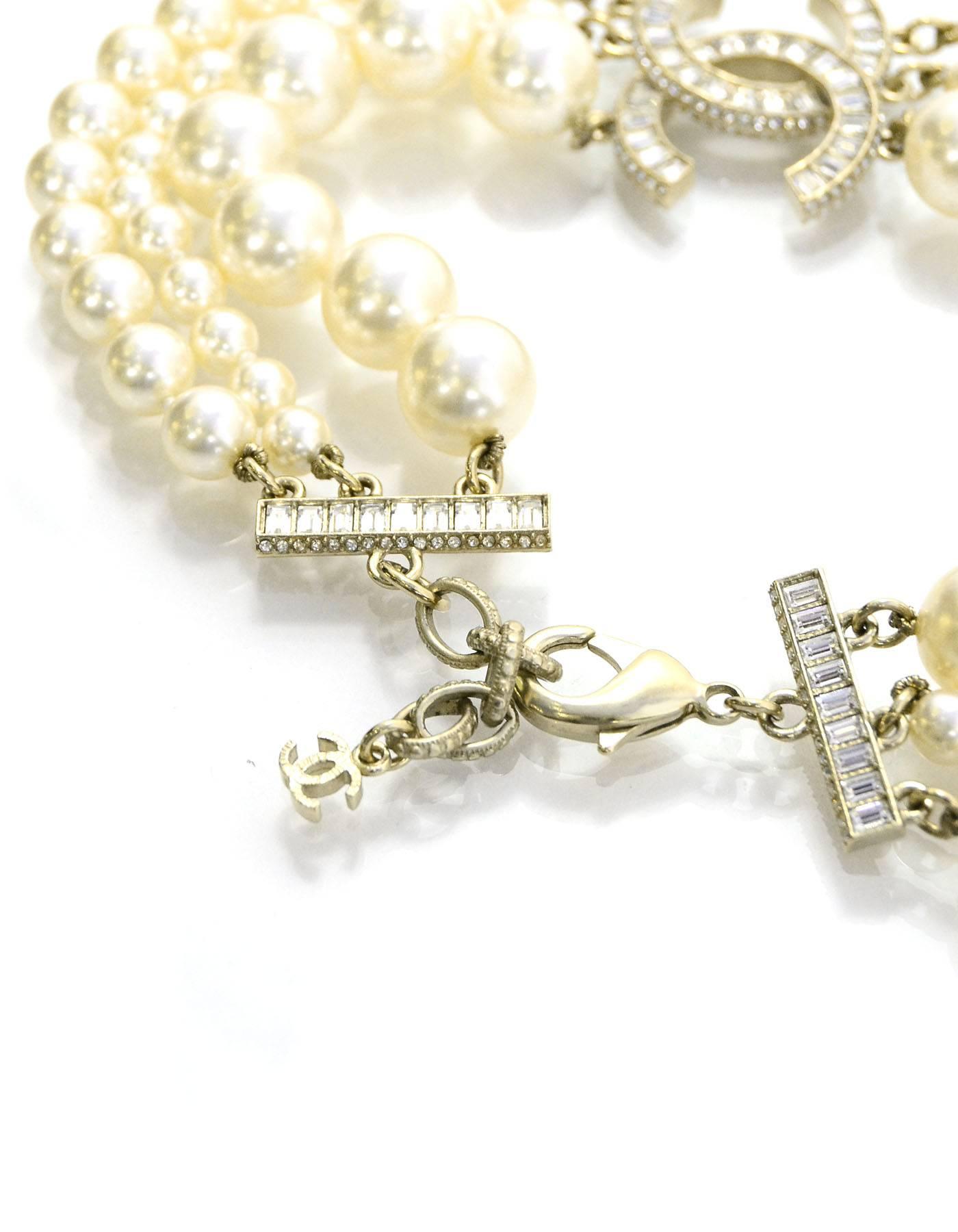 10% Authentic Chanel 3-Strand Pearl & Crystal CC Choker Necklace.  CC pendant feature baguette crystals.  Three strands of different sized pearls.

Made In: France
Year of Production: 2014
Color: Ivory and pale goldtone
Materials: Metal, faux pearl