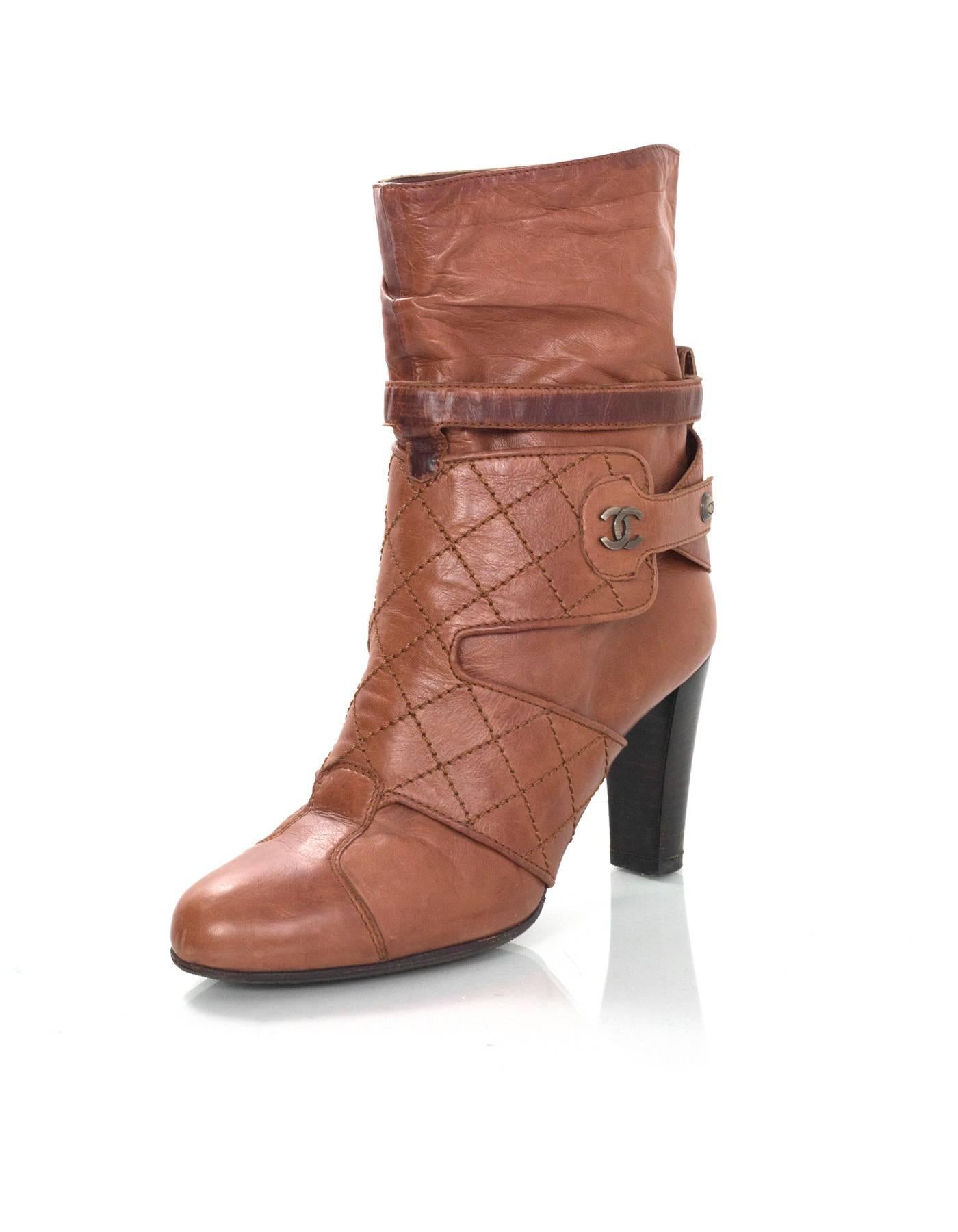 Chanel Tan Ankle Boots Sz 37

Made In: Italy
Color: Tan
Materials: Leather
Closure/Opening: Slide on
Sole Stamp: CC Made In Italy 37
Overall Condition: Very good pre-owned condition with the exception of being re-soled, light scuffs and waters marks